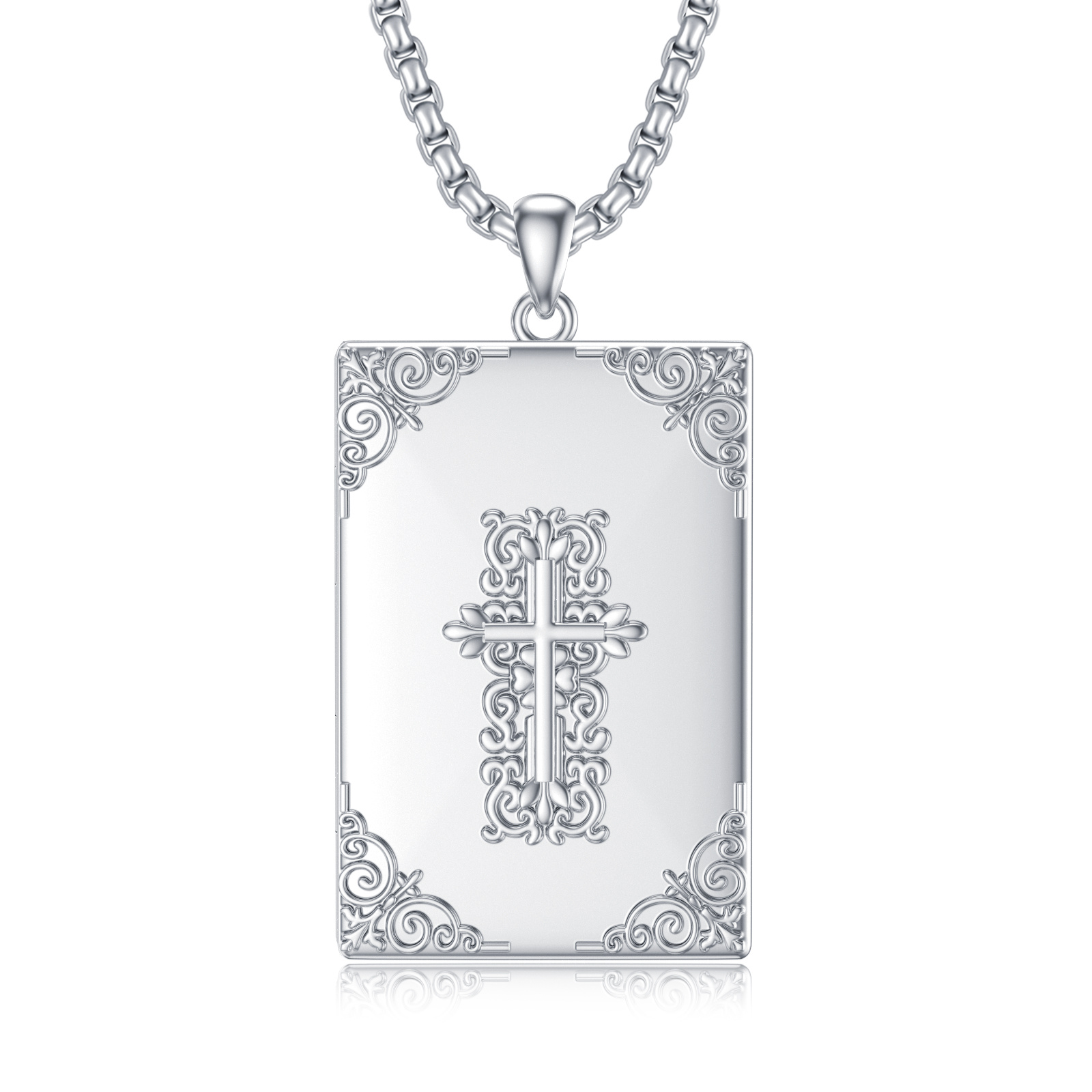 Silver rectangular pendant on a chain featuring intricate scrollwork and a central cross design on a shiny surface.