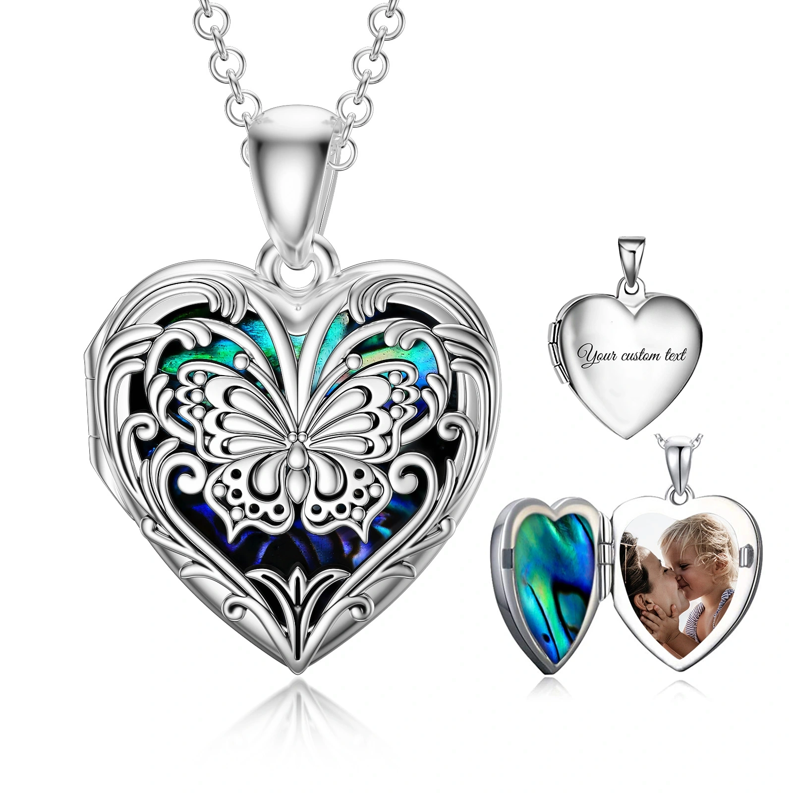 Silver heart-shaped locket pendant with an intricate butterfly motif and blue-green enamel, on a chain.