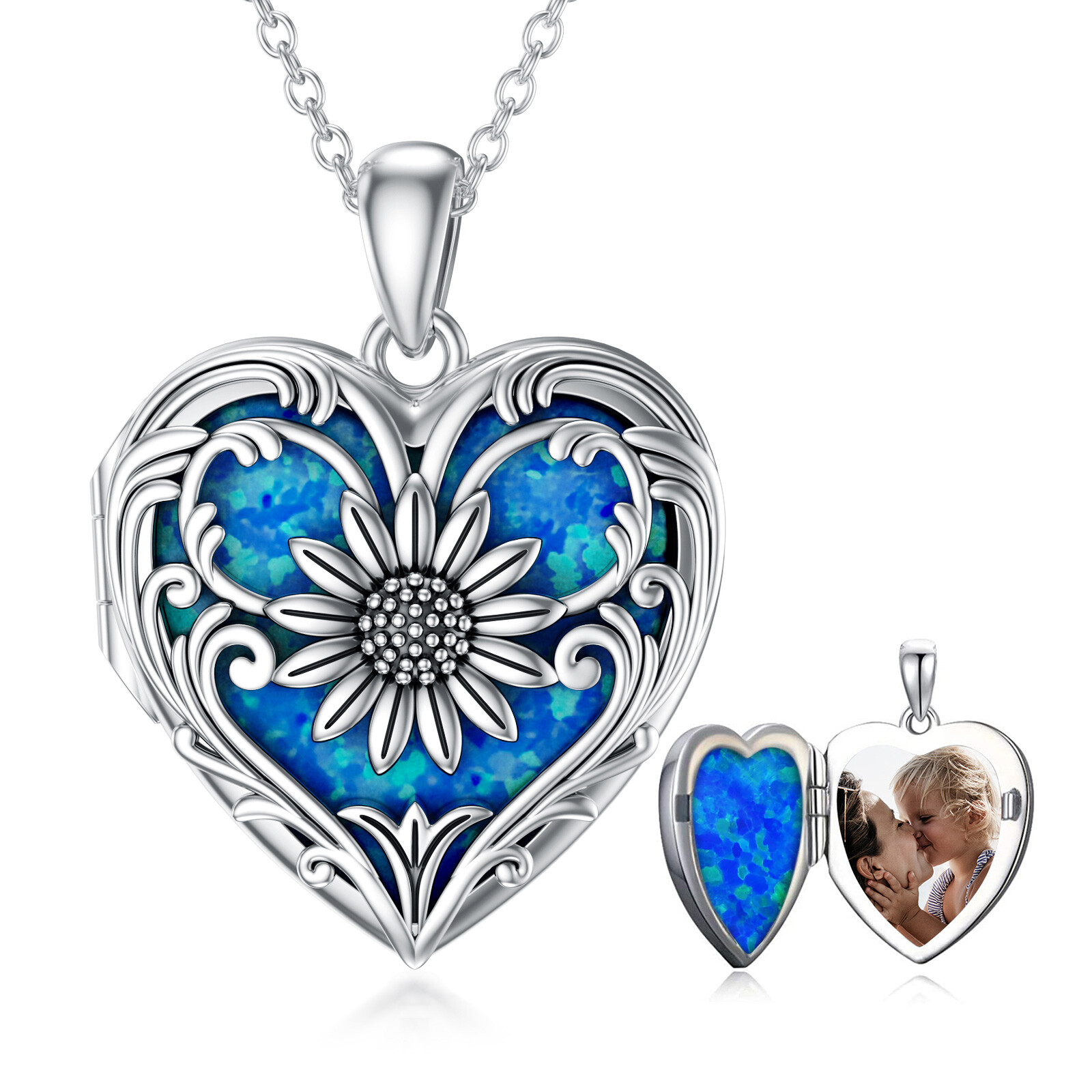 Heart-shaped silver pendant with blue inlay and floral design on chain, product shot in white background.