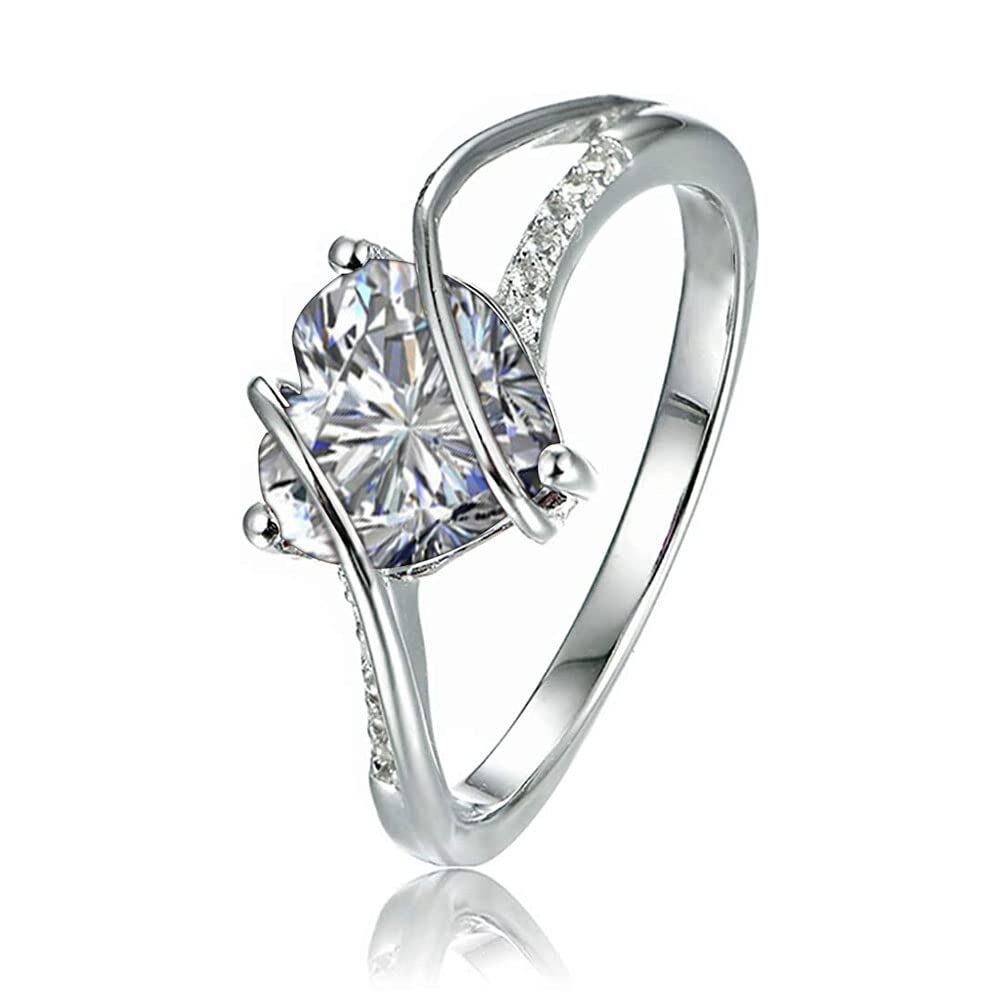 Silver engagement ring with a large cushion-cut diamond centerpiece and pavé accents on a curved band, shown at an angle with reflection.