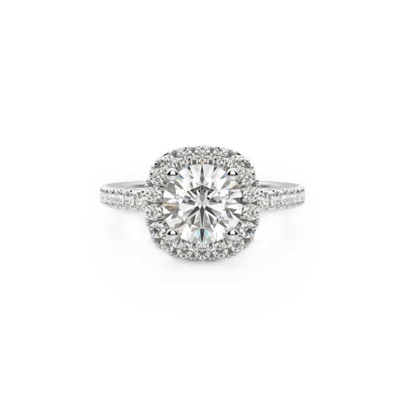 Diamond halo engagement ring with a large central stone and pavé-set band on a white background.