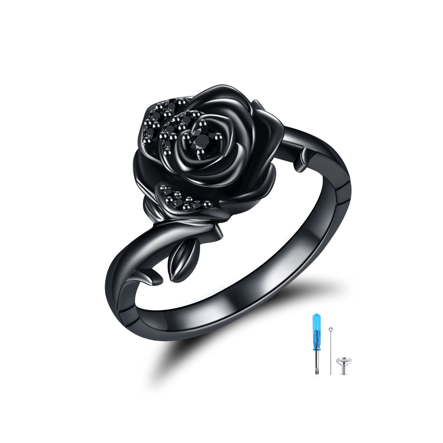 Black rose-shaped ring with a glossy gunmetal finish and inlaid black stones, shown with a small tool set beside it (jewelry kit).