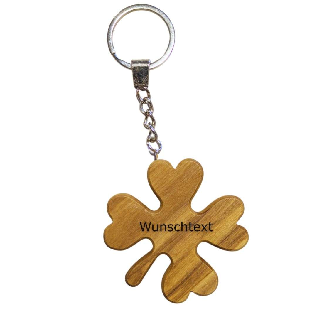 Wooden flower-shaped keychain with a metal ring and chain; surface reads 'Wunschtext' (customizable).