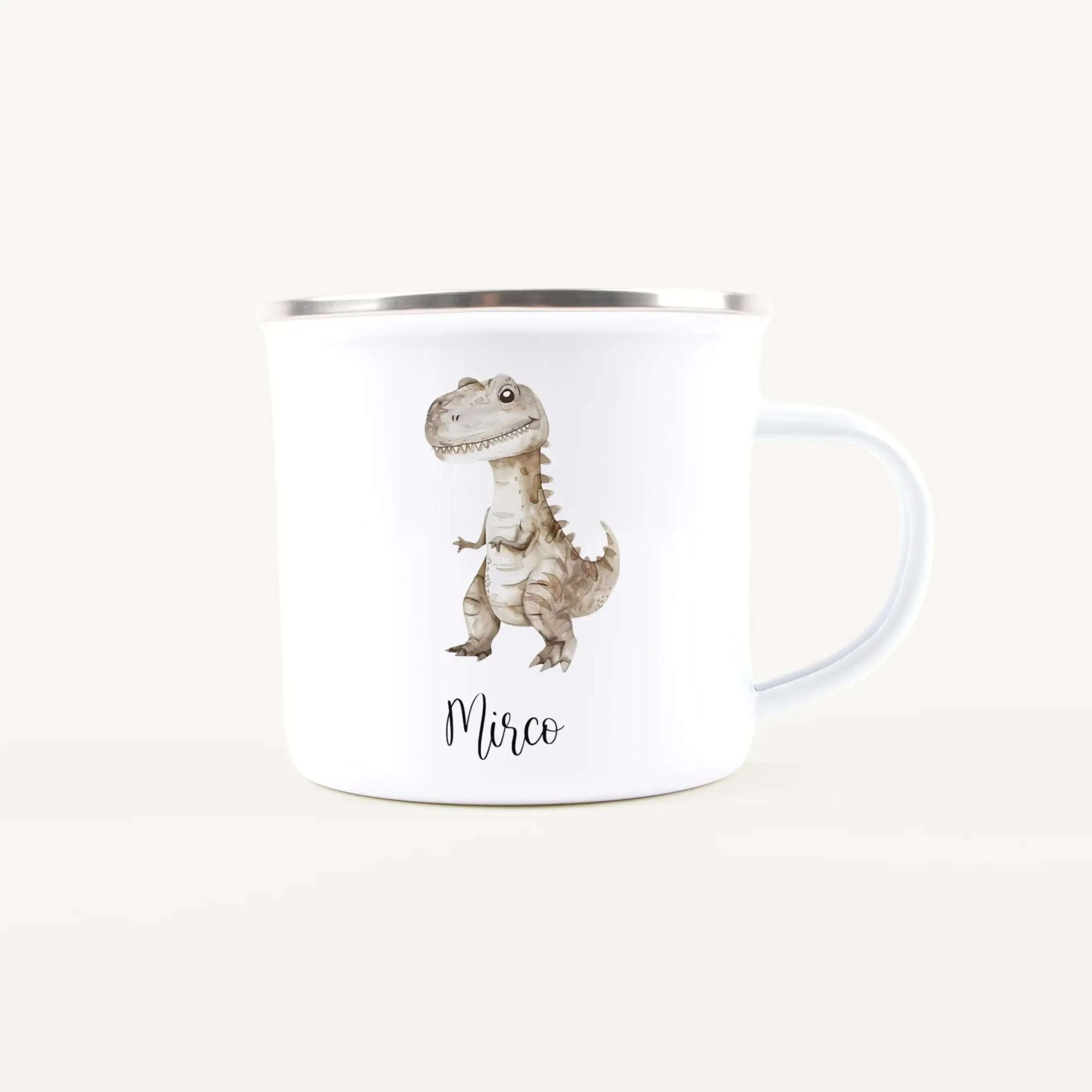 White ceramic mug with a shiny metal rim featuring a cartoon dinosaur illustration on the side.