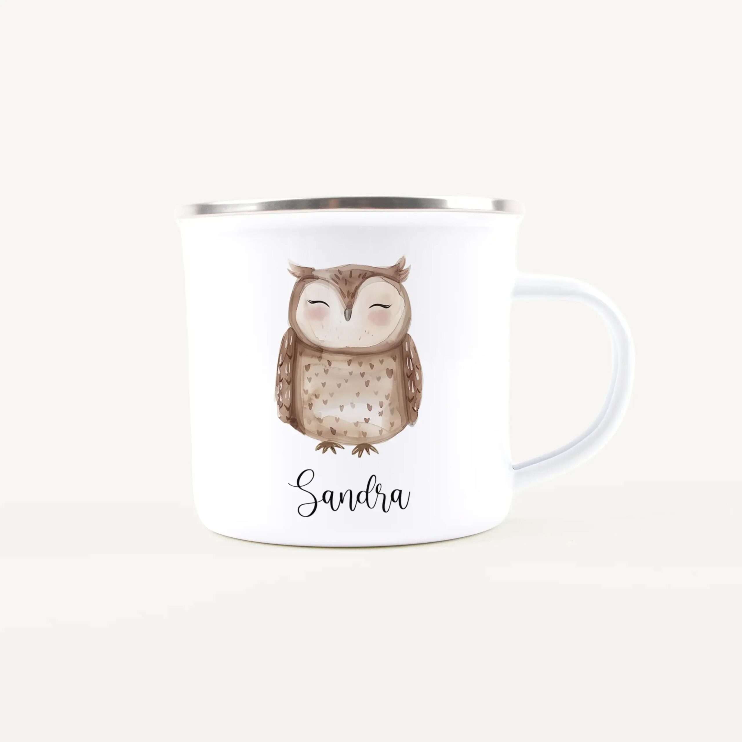 White ceramic mug with a brown owl illustration and the name Sandra in cursive on the front, silver rim visible at the top
