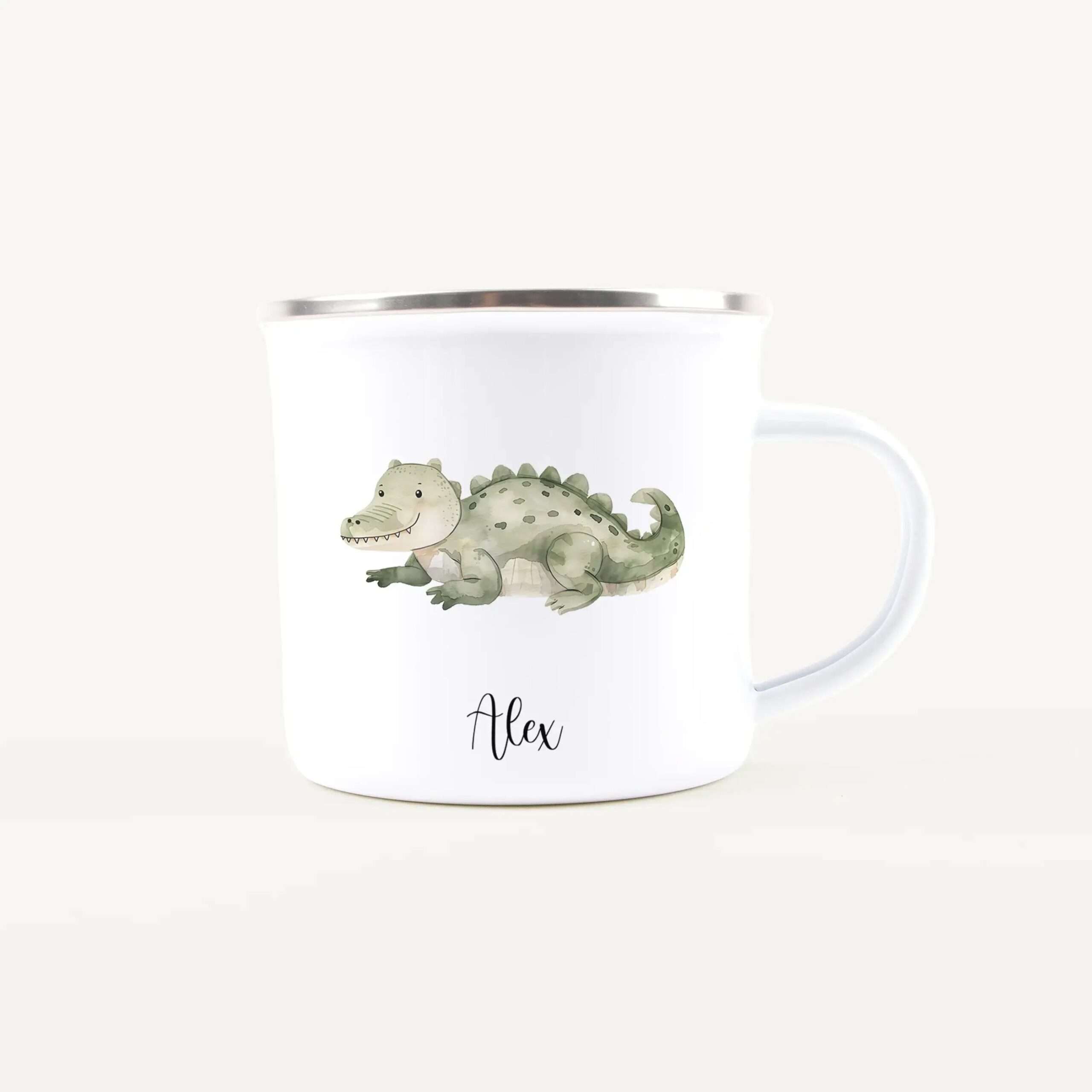 White ceramic mug with a green cartoon dinosaur illustration and the name Alex on the front
