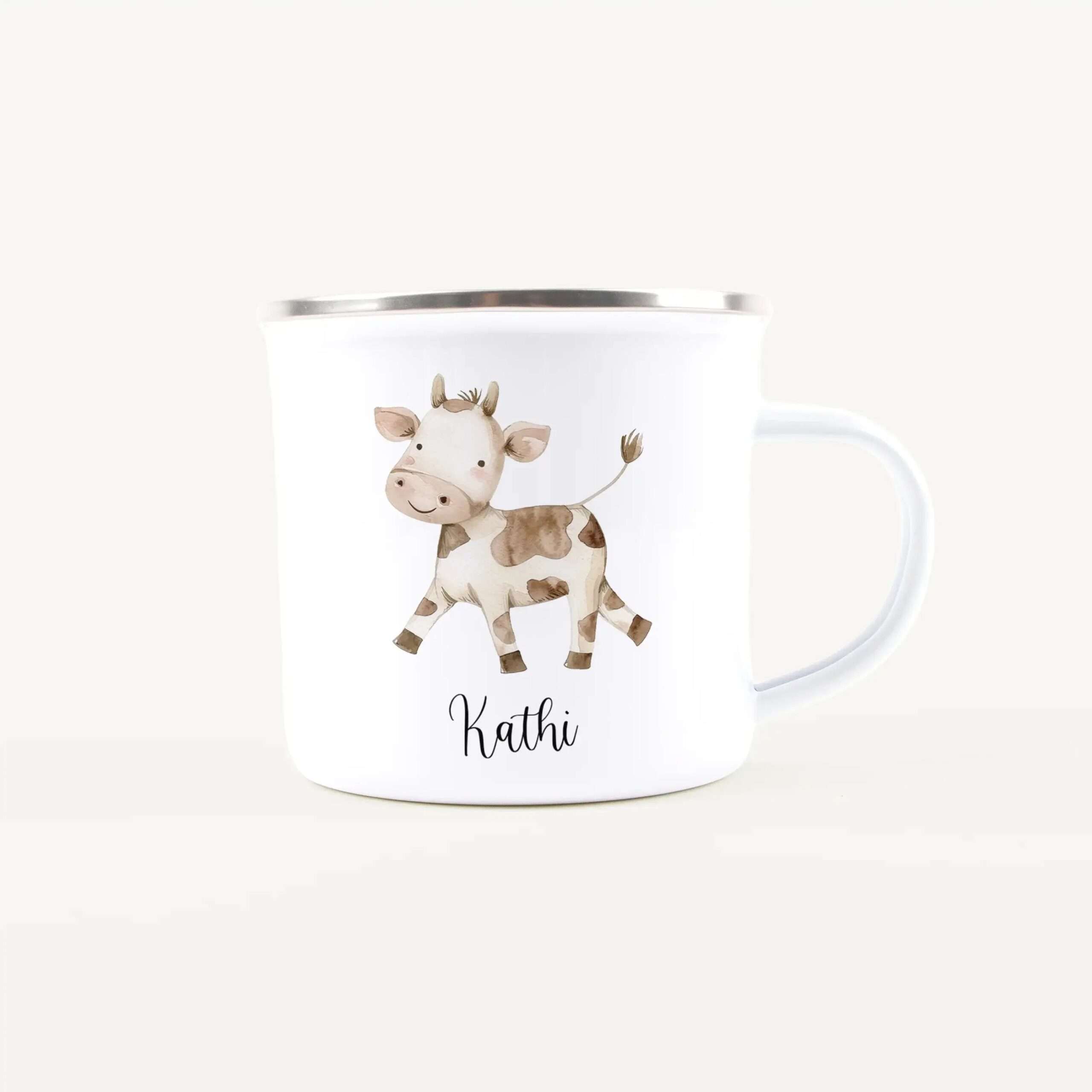 White ceramic mug showing a cute cartoon cow and the name 'Kathi' printed on its side, visible near the bottom of the image.