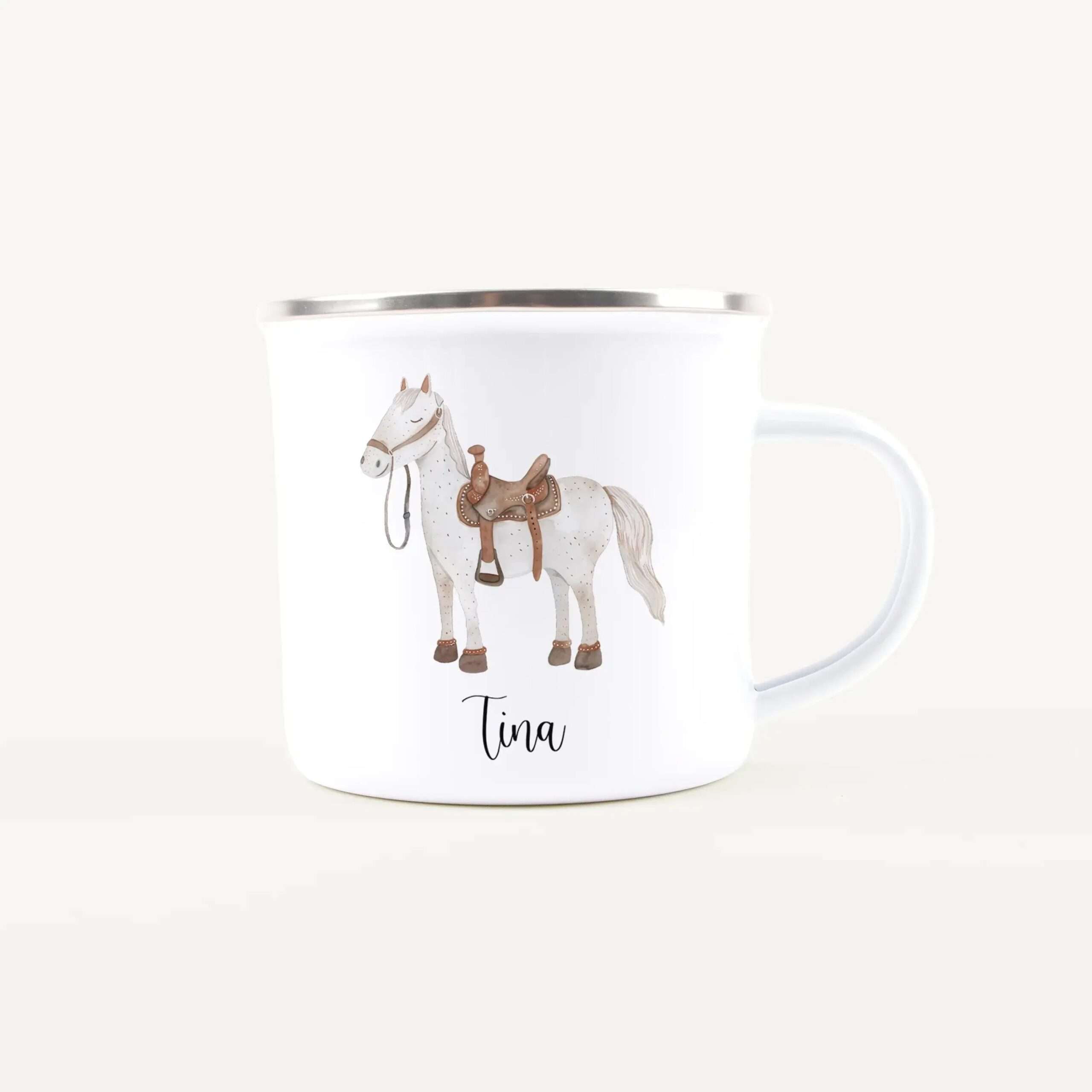 White ceramic mug shown from the side with a cartoon horse illustration and decorative saddle details, with the name 'Tina' partially visible on the rim area.