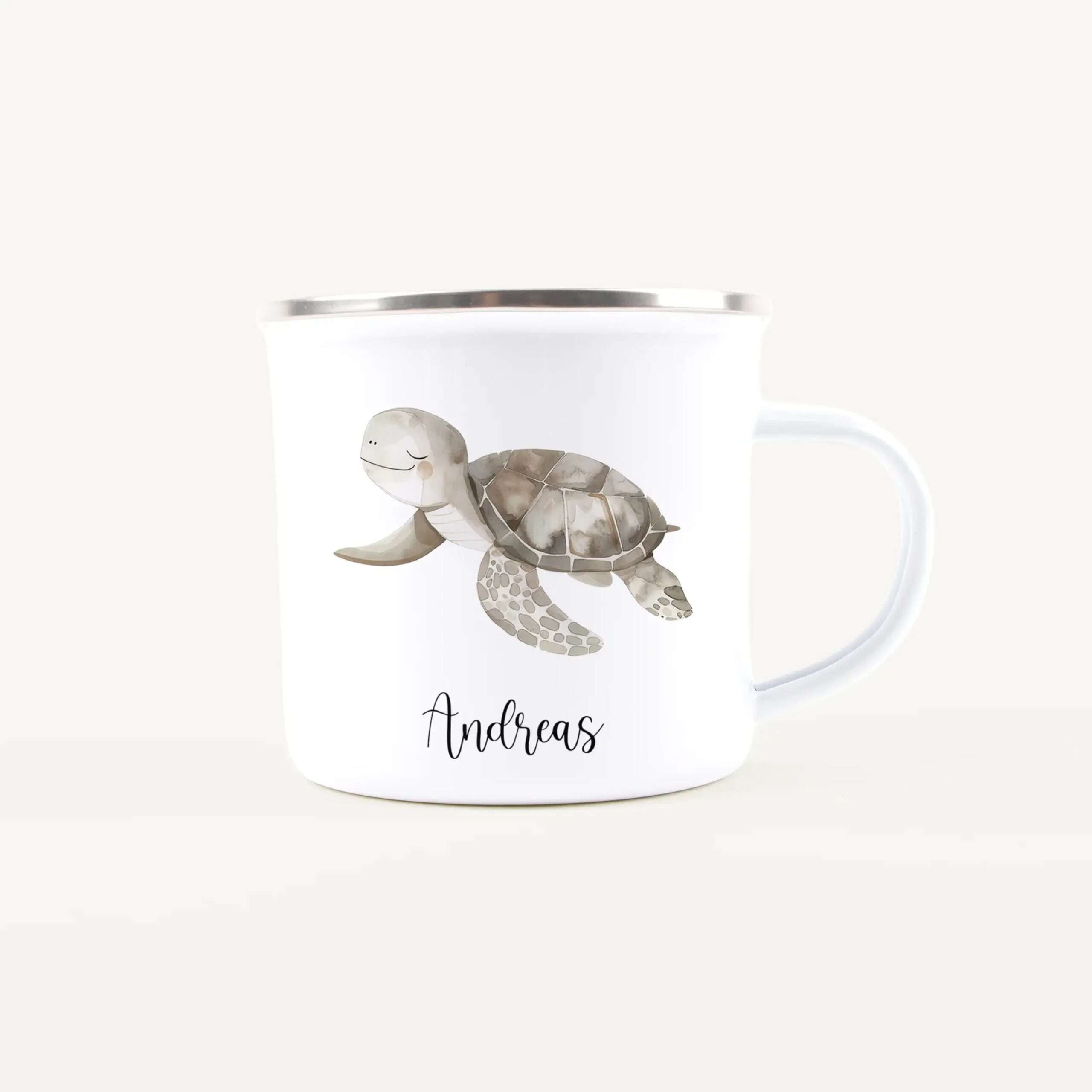 White mug with a silver rim featuring a smiling watercolor turtle and the name Andreas printed on the front