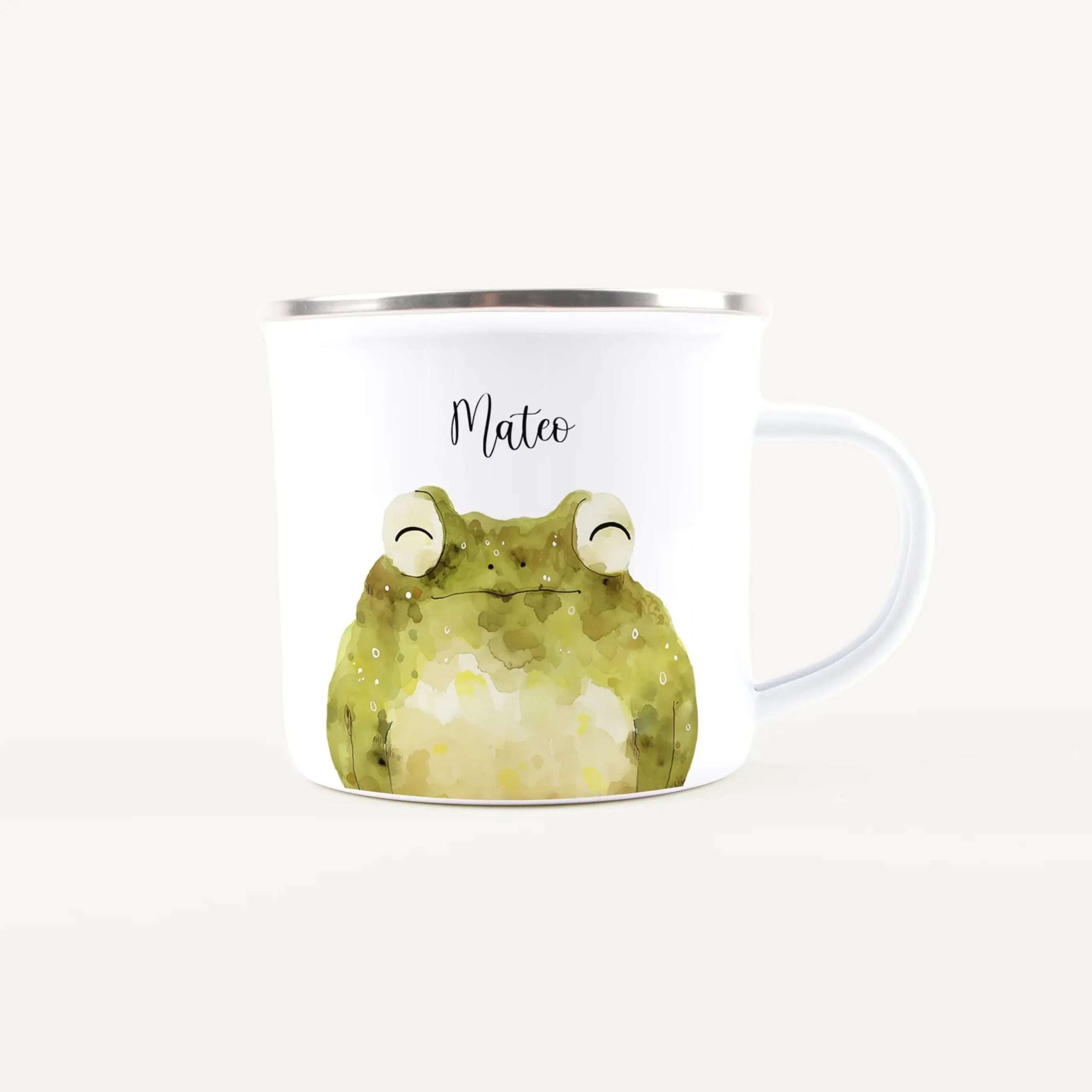 White ceramic mug with a watercolor green frog illustration and the name Mateo on the side.
