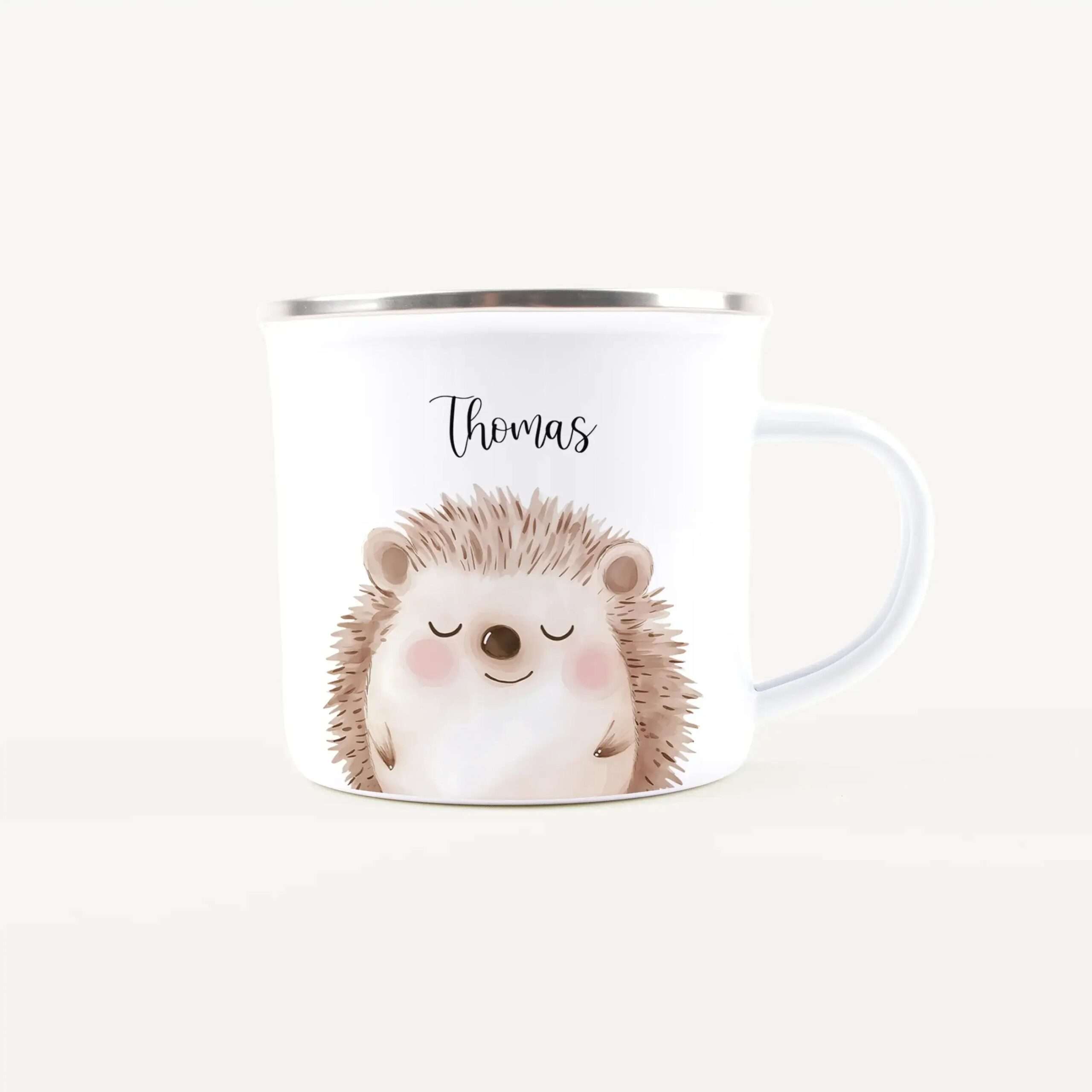 White ceramic mug featuring a cute hedgehog illustration and the name 'Thomas' on the side.