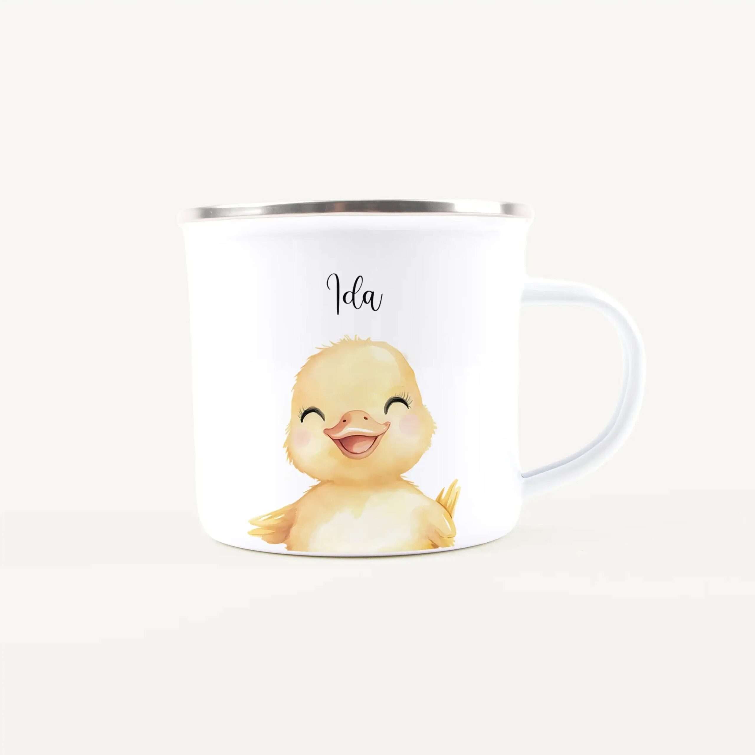 White mug with a cheerful yellow baby chick illustration on the front, against a light background; text 'Ida' partially visible above the image.