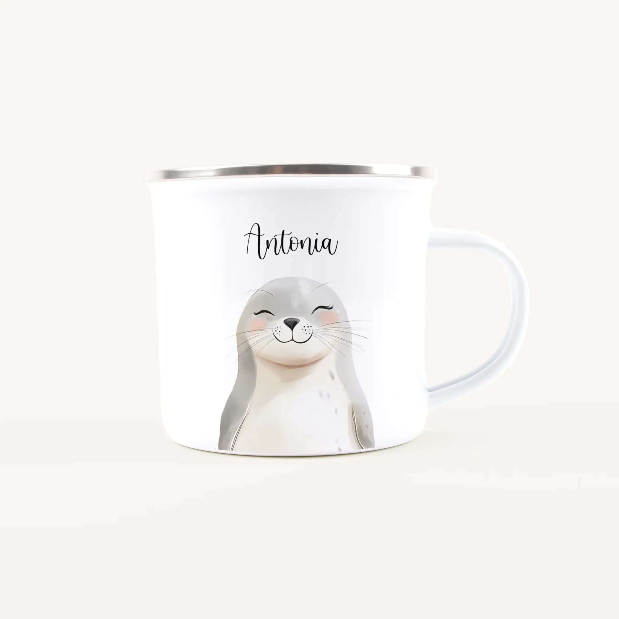 White mug with a silver rim featuring a cute rabbit illustration and the name 'Antonia'.