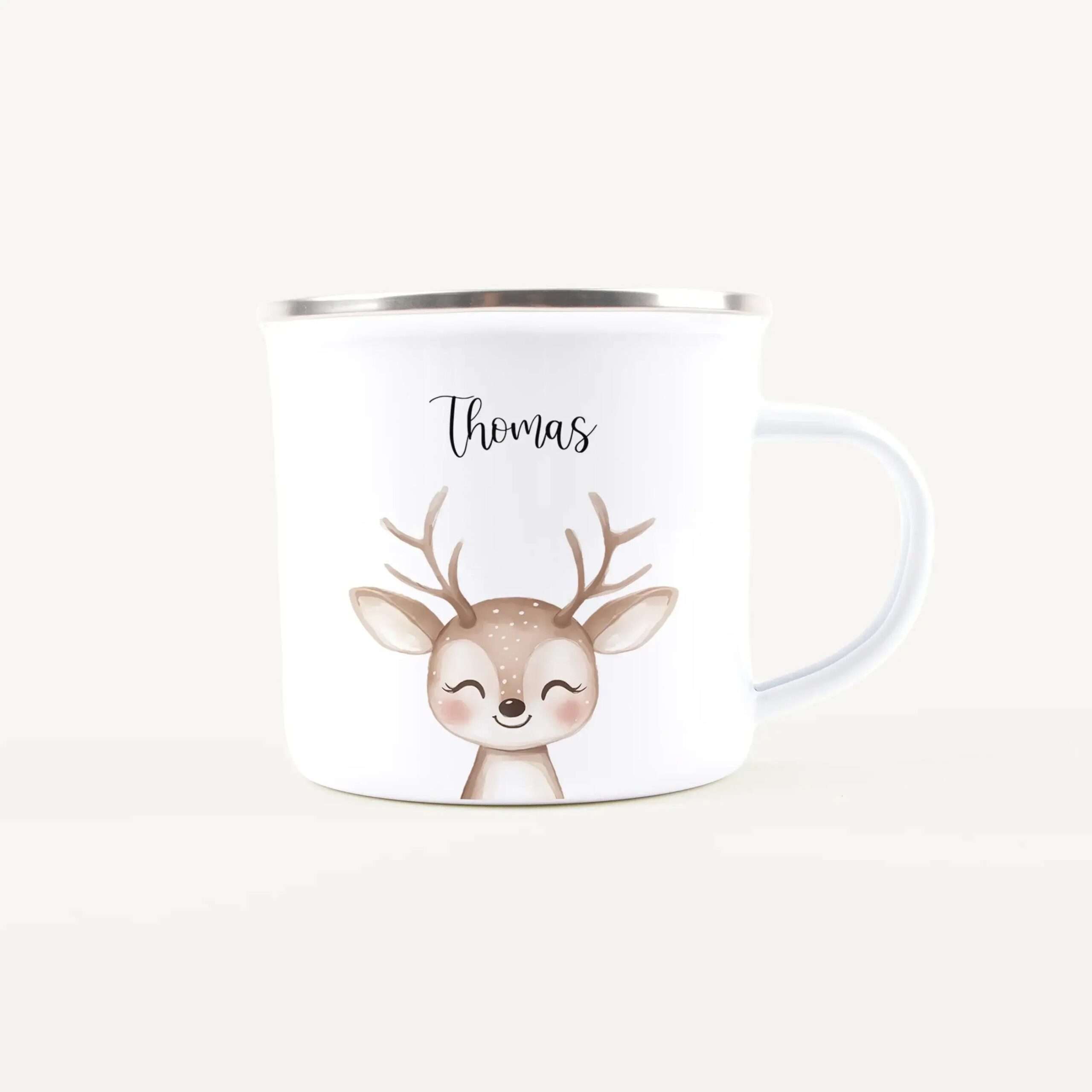 White ceramic mug featuring a smiling cartoon deer with the name Thomas above it.