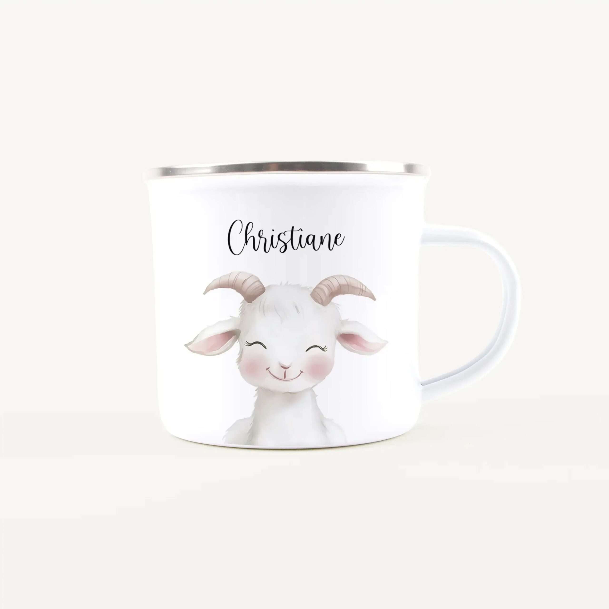 Personalized white mug with a cute illustrated goat and the name 'Christiane' on it, silver rim visible.