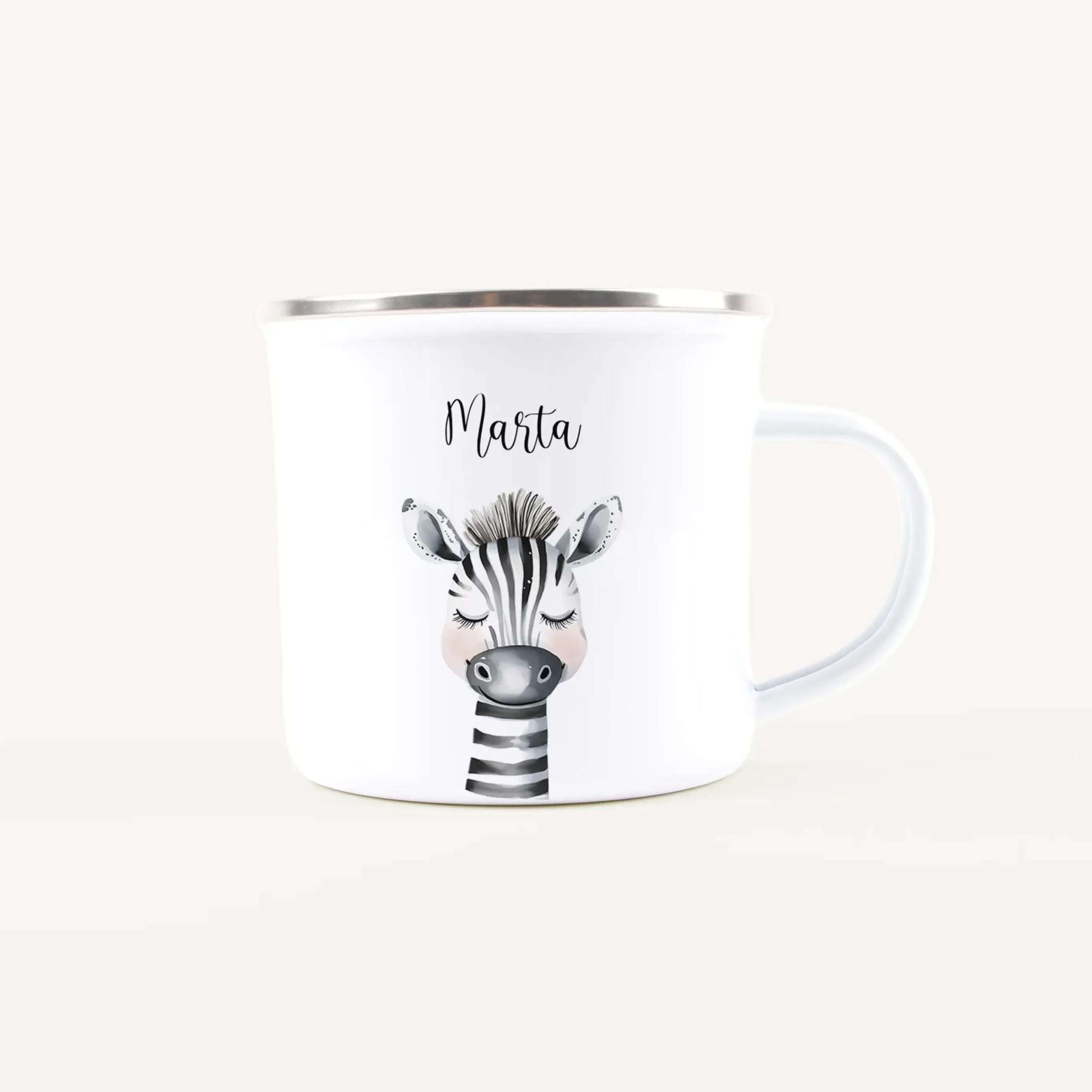 White ceramic mug with a silver rim featuring a black-and-white zebra illustration and the name Marta