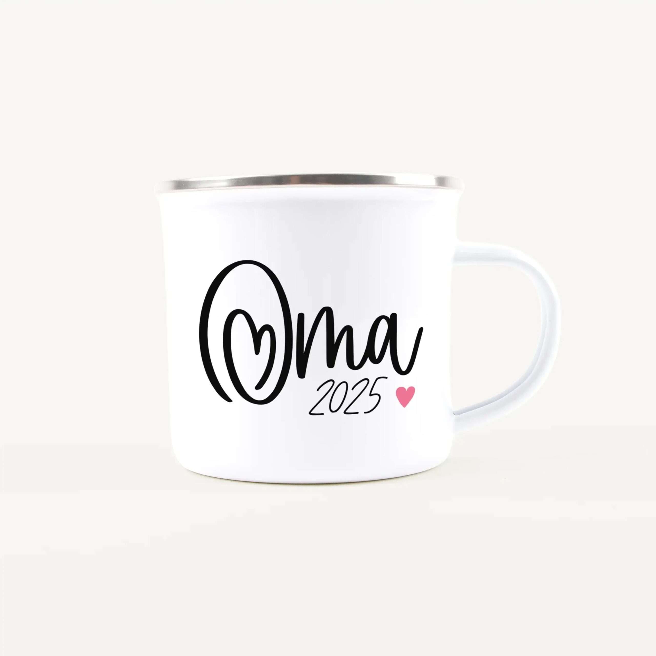 Close-up of a white ceramic mug with black cursive lettering and a small pink heart emblem.