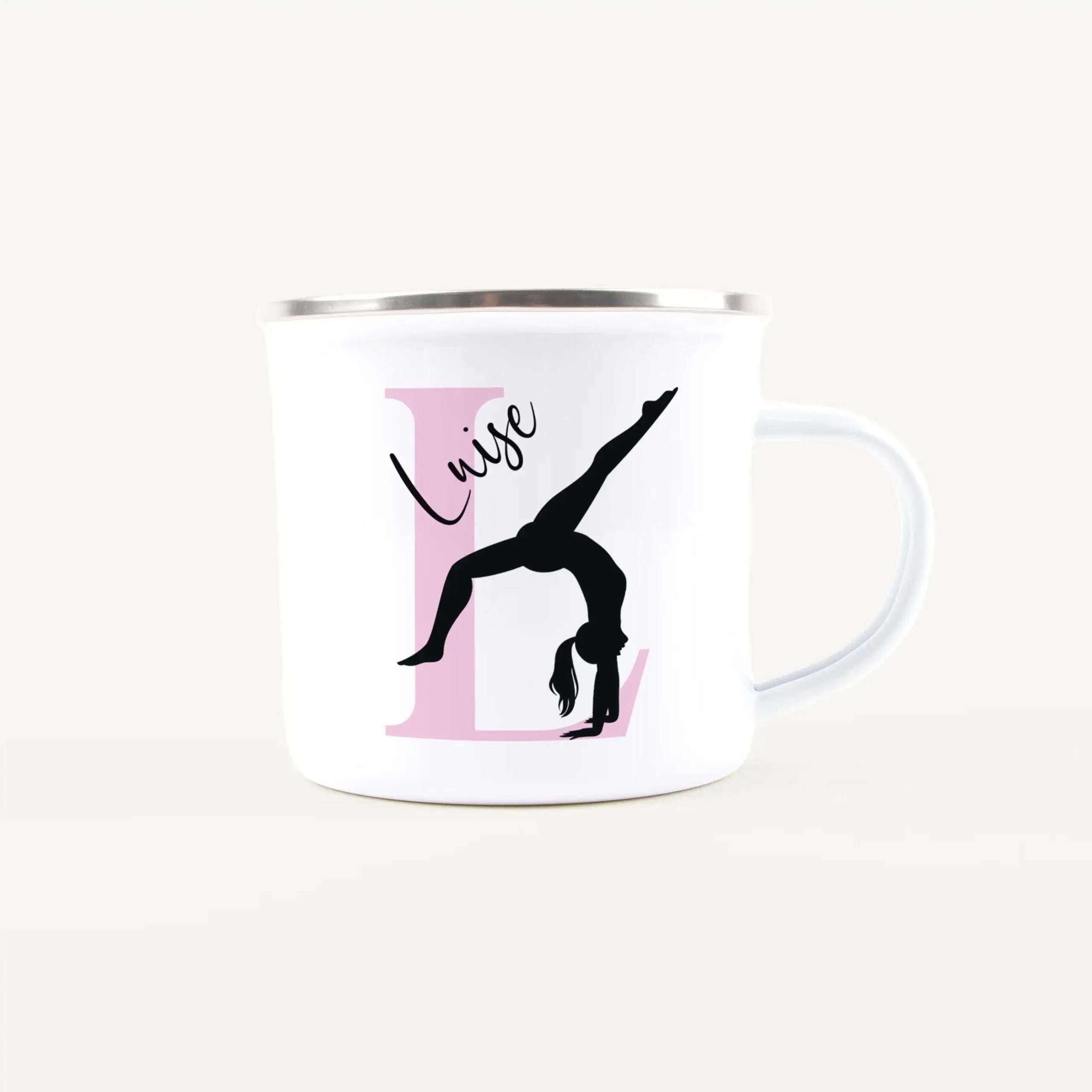 White mug with a pink rectangular graphic and black silhouette of a dancer, partial view of the design visible on the cup surface.