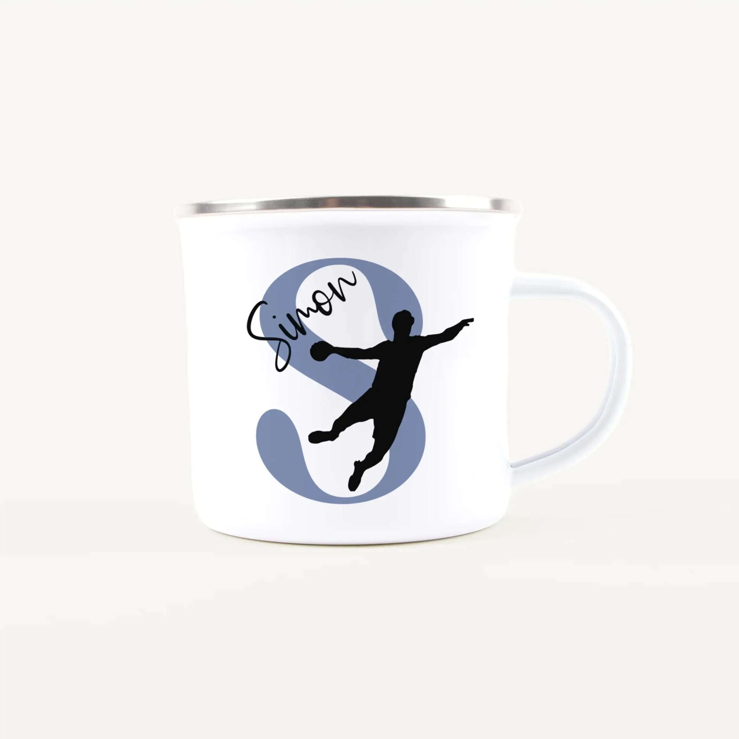 White mug decorated with a blue circle containing a black dancing silhouette and cursive lettering along the circle’s edge, with the handle partially visible on the right.