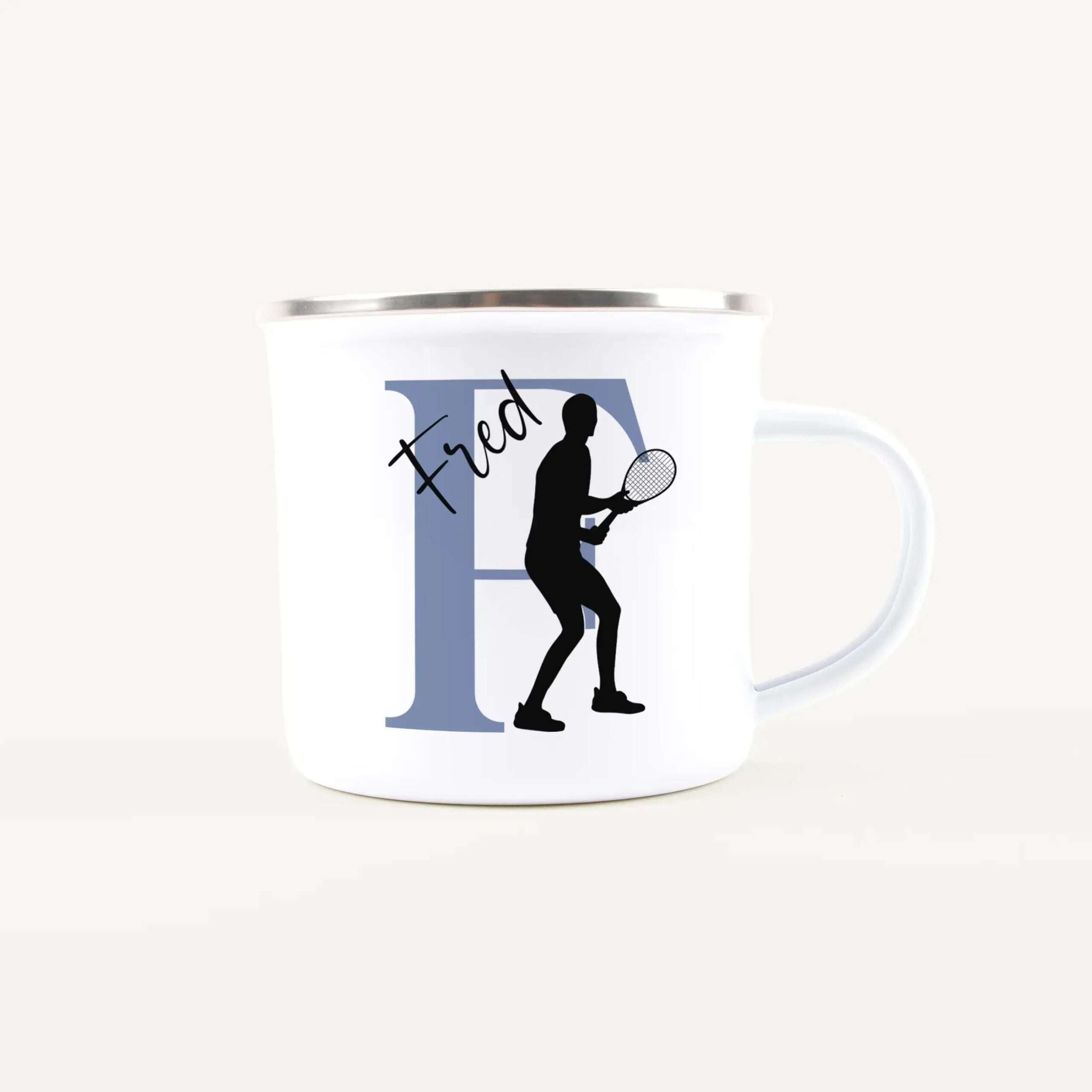 White coffee mug featuring a blue rectangular panel with a black tennis player silhouette and racket design (informational graphic).