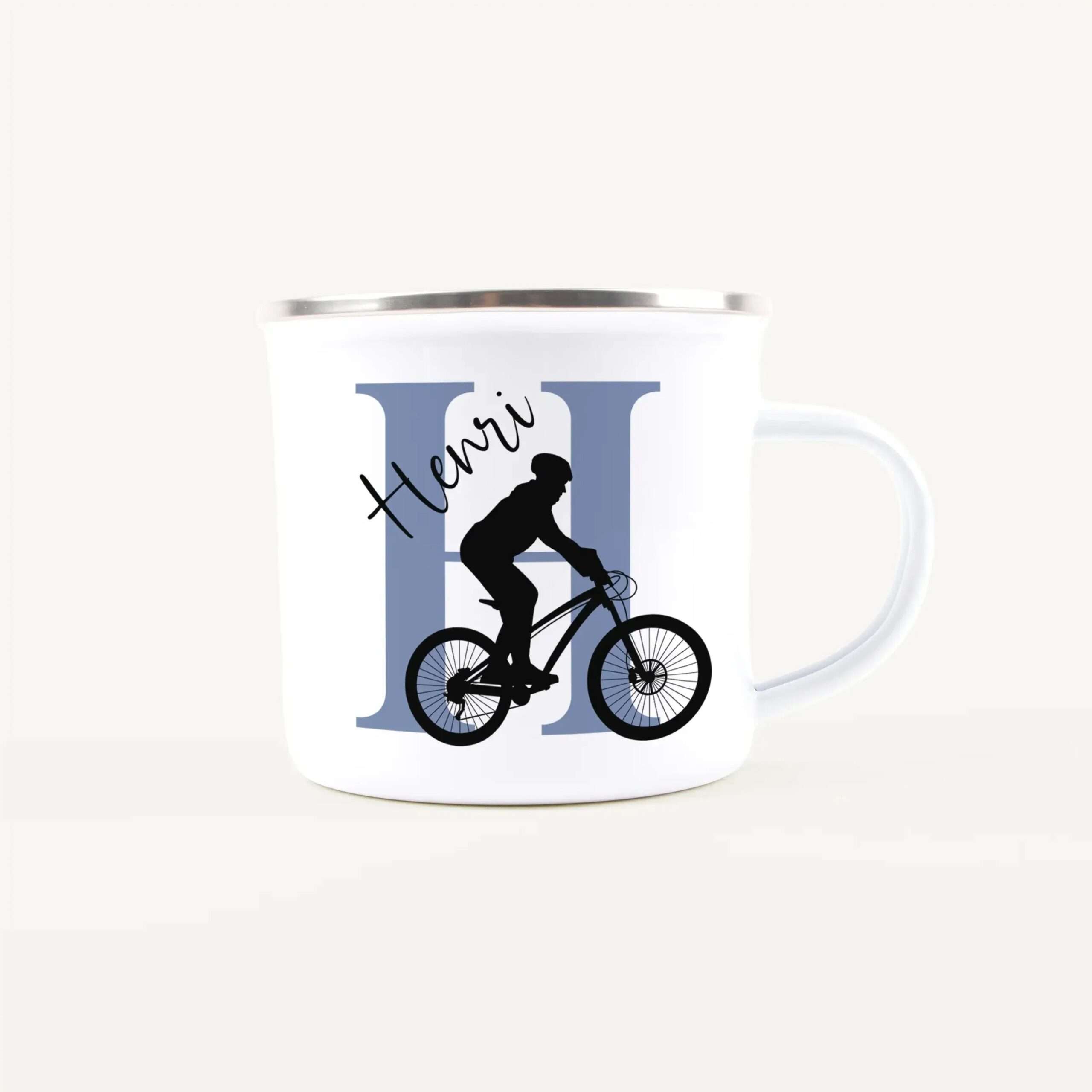 White mug with a cyclist silhouette riding a bike over a blue vertical-panel backgrounded design, conveying a cycling theme
