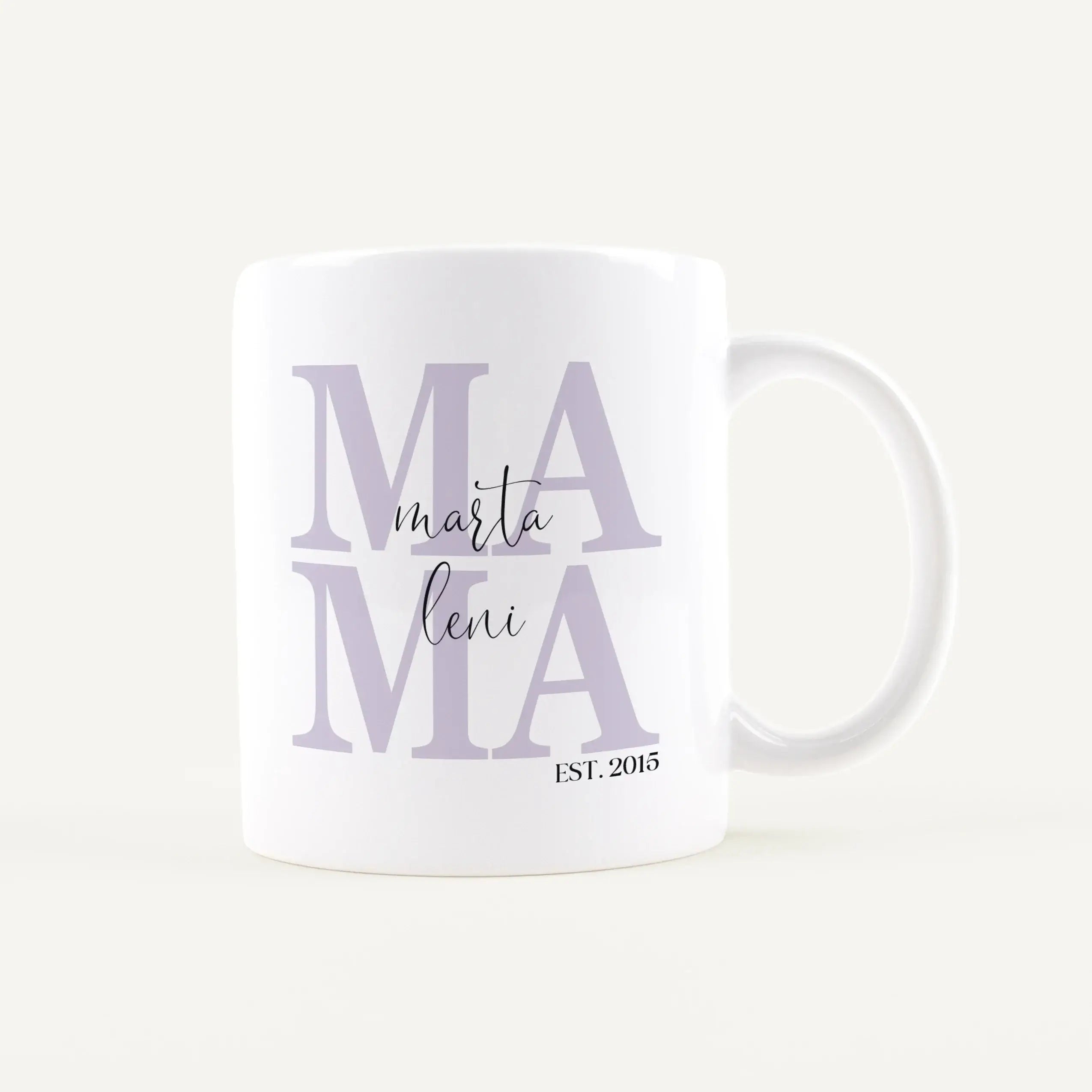 Close-up of a white mug with large lavender letters spelling ‘MAMA’ and a cursive name beneath, plus EST. 2015 at the bottom.