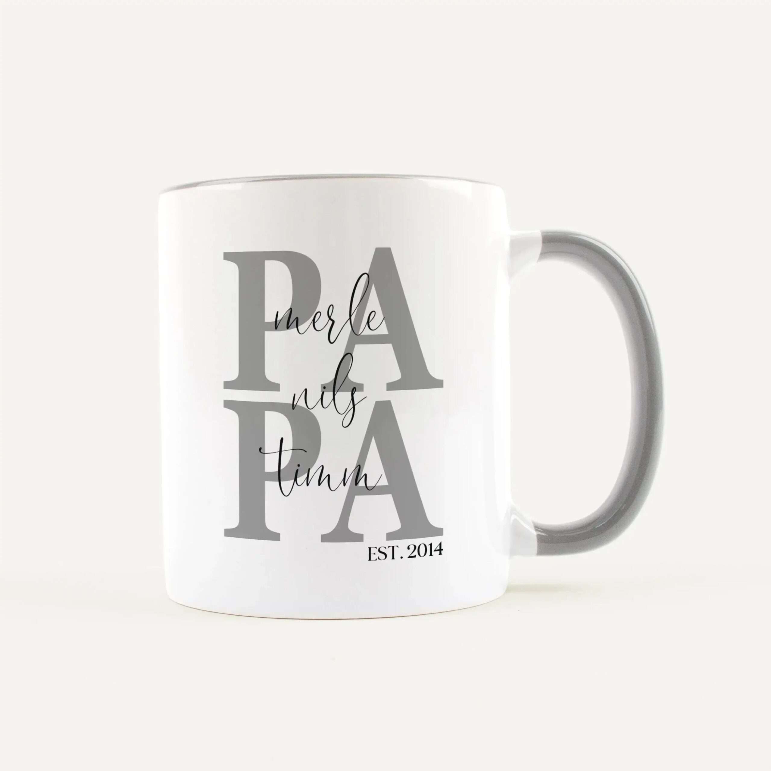 White ceramic mug featuring large gray letters forming 'LA' overlaid with cursive 'merle' and 'EST. 2014'