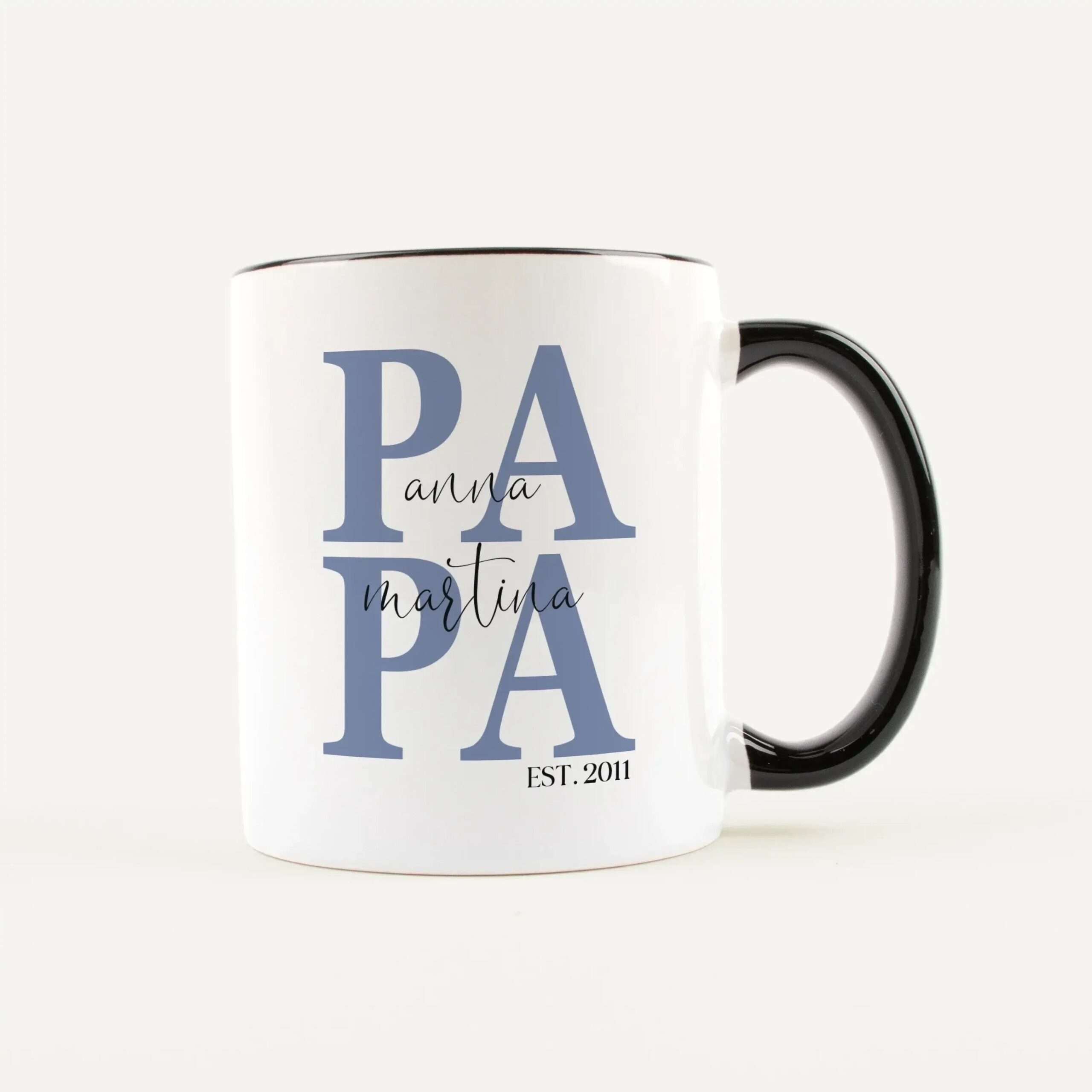 White ceramic mug featuring large blue 'PAPA' lettering with a cursive 'mart a' overlay and 'EST. 2011' at the bottom, black handle visible on the right.