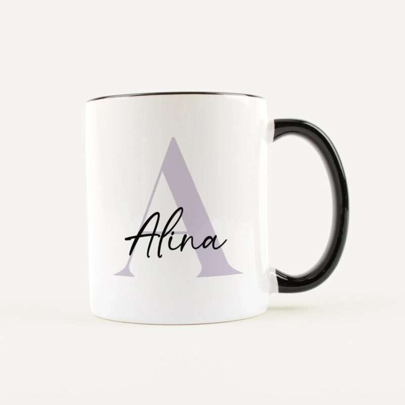 Close-up of a white mug with a light purple triangle and black script text, handle on the right.