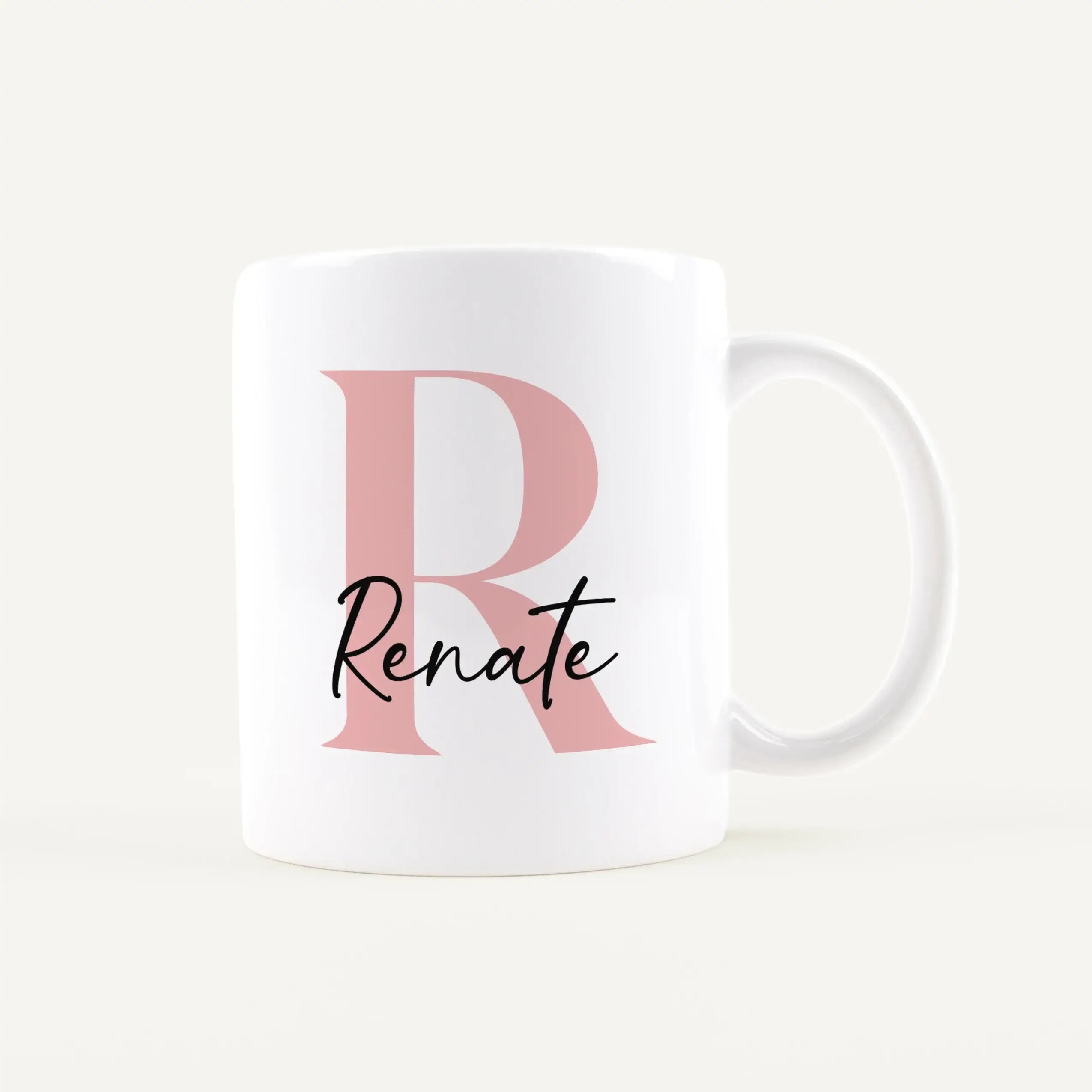 White ceramic mug with a large pink letter D and black cursive text on the front.