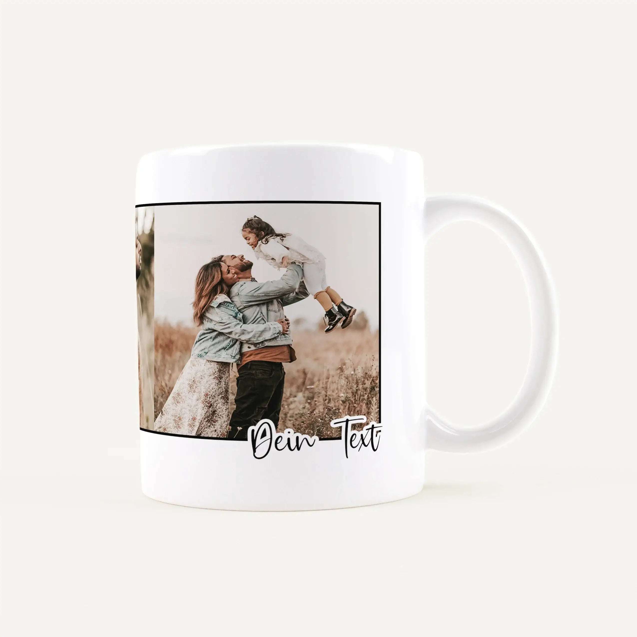 White ceramic mug displaying a family photo (parents lifting a child) with the placeholder text 'Dein Text' along the bottom edge of the photo frame on the mug.