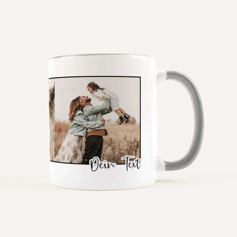 White ceramic mug with a family photo of a couple lifting a child, and the text 'Dein Text' printed at the bottom edge.