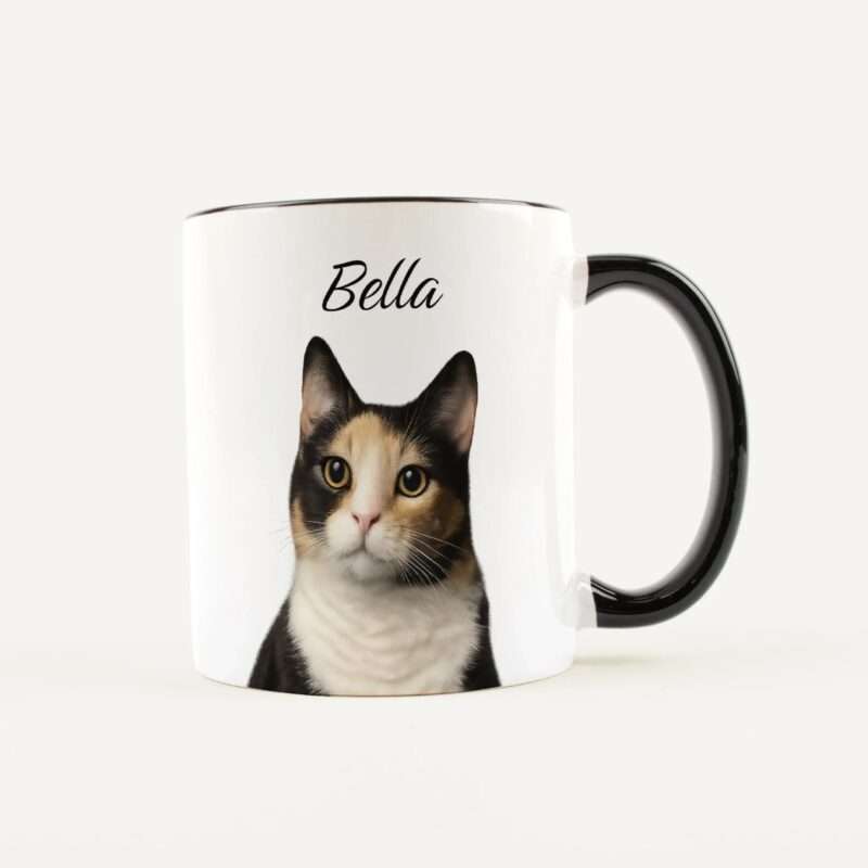 White ceramic mug with a printed cat face and the name 'Bella' visible on the side near the rim