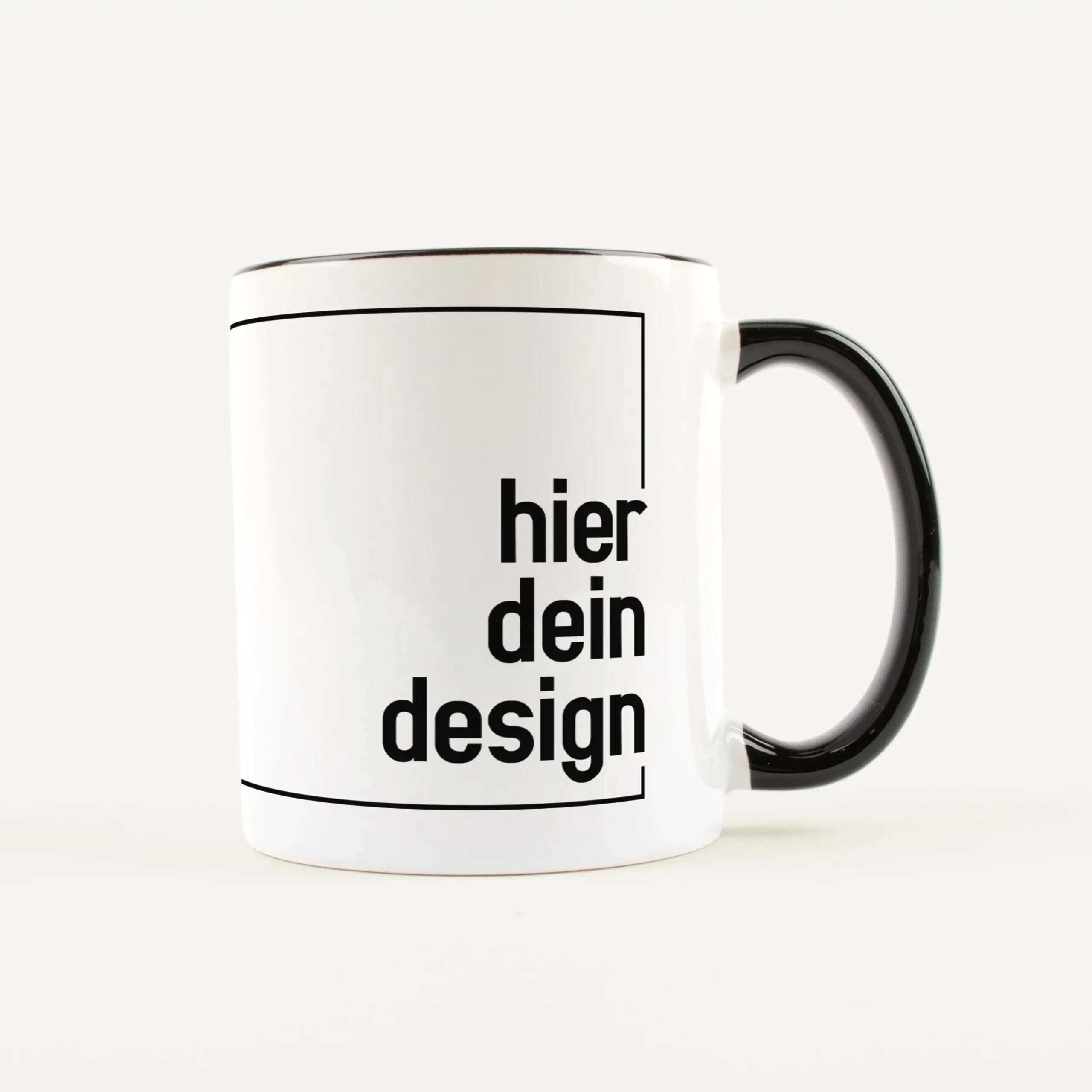 White mug with black typography along the side, the word 'design' visible.