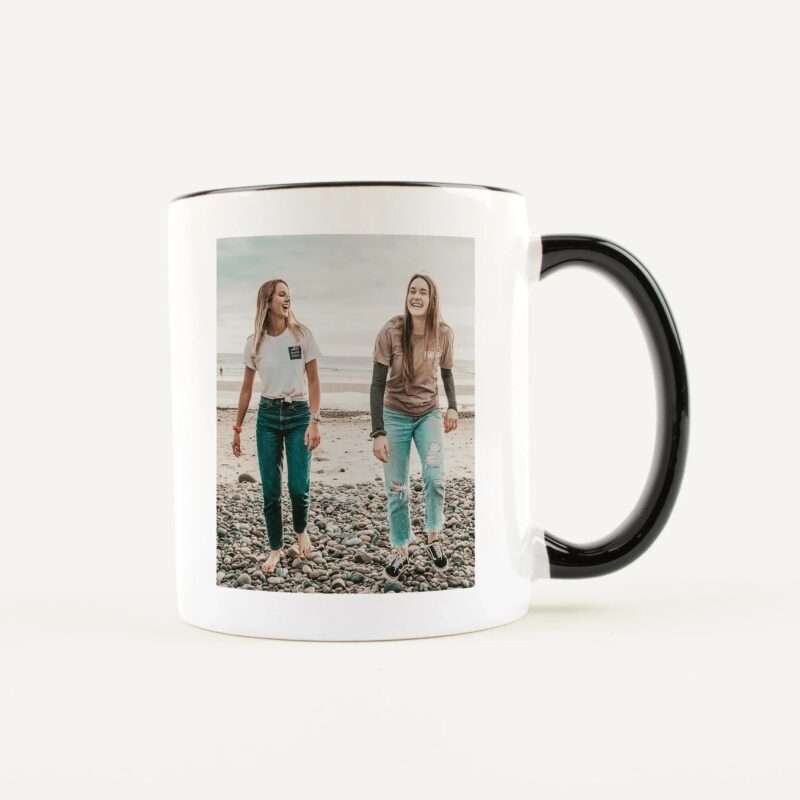 White mug featuring a photo of three smiling friends at the beach on its surface