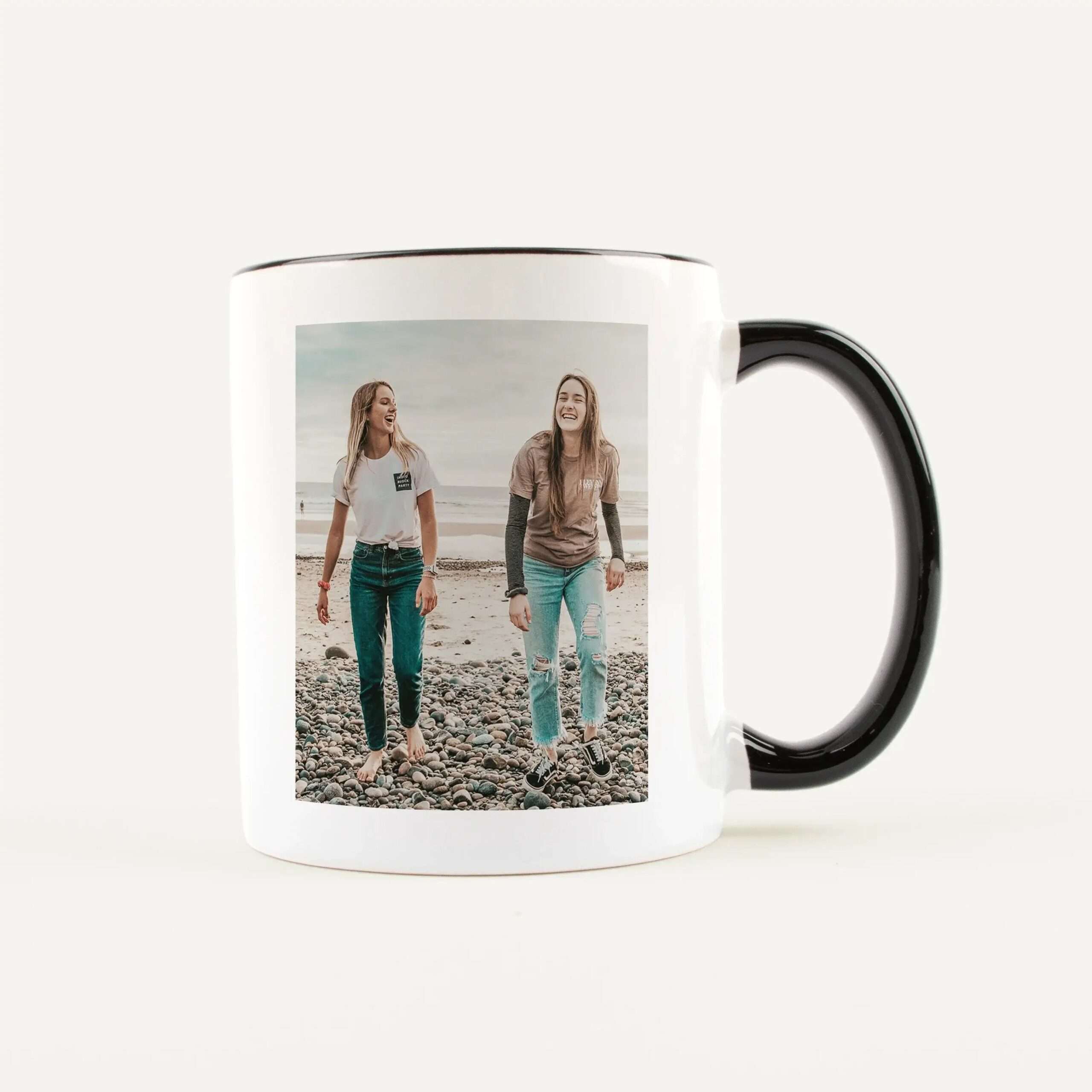 White mug featuring a photo of three smiling friends at the beach on its surface