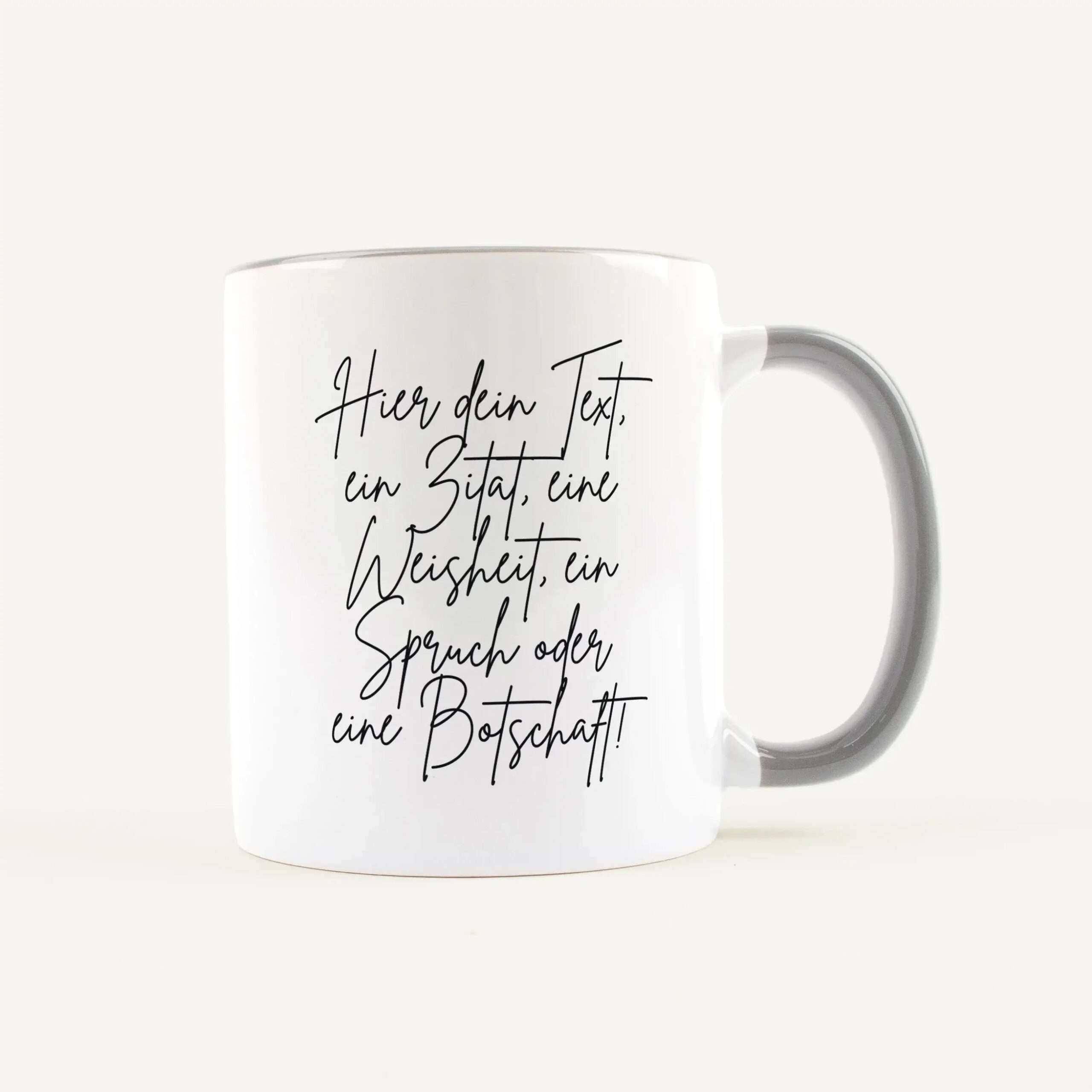 White ceramic mug featuring black cursive German text printed along the side (text visible: 'Hier dein Text').