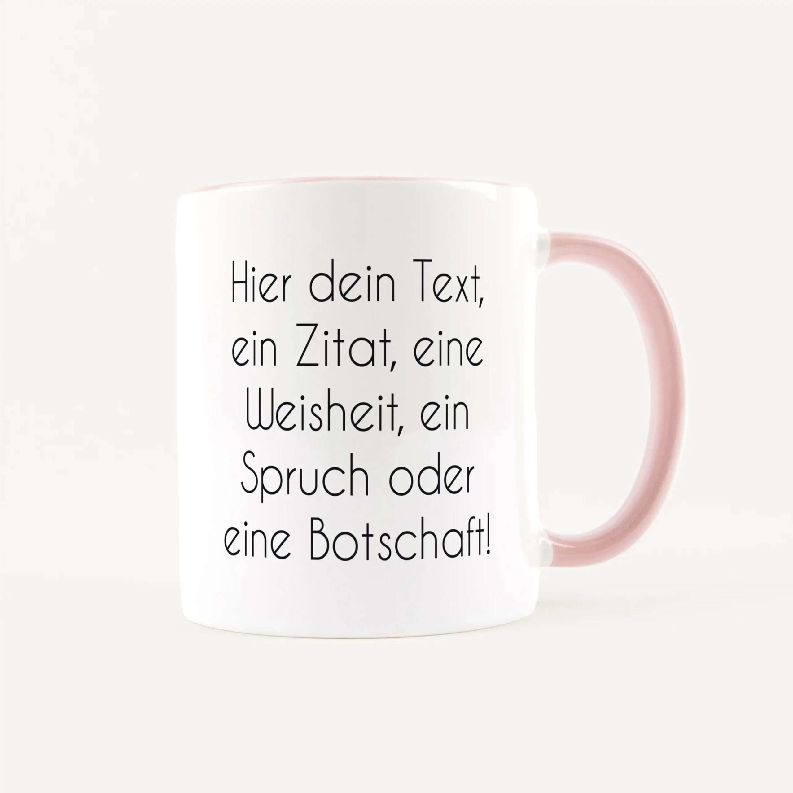 White mug with a pink handle featuring German placeholder text printed on its surface.