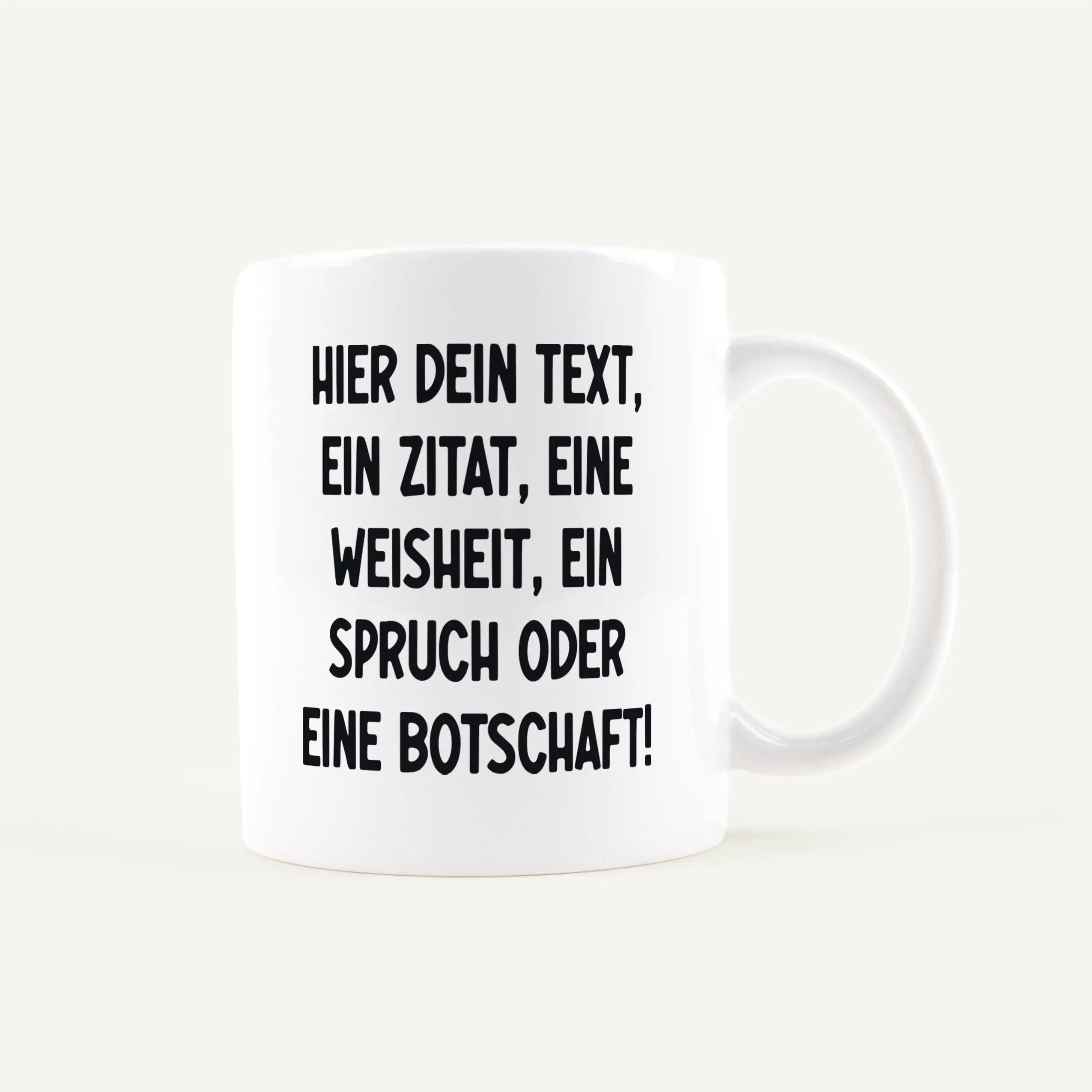 White ceramic mug with large bold German text as a text placeholder (visible: HIER DEIN TEXT, ...).