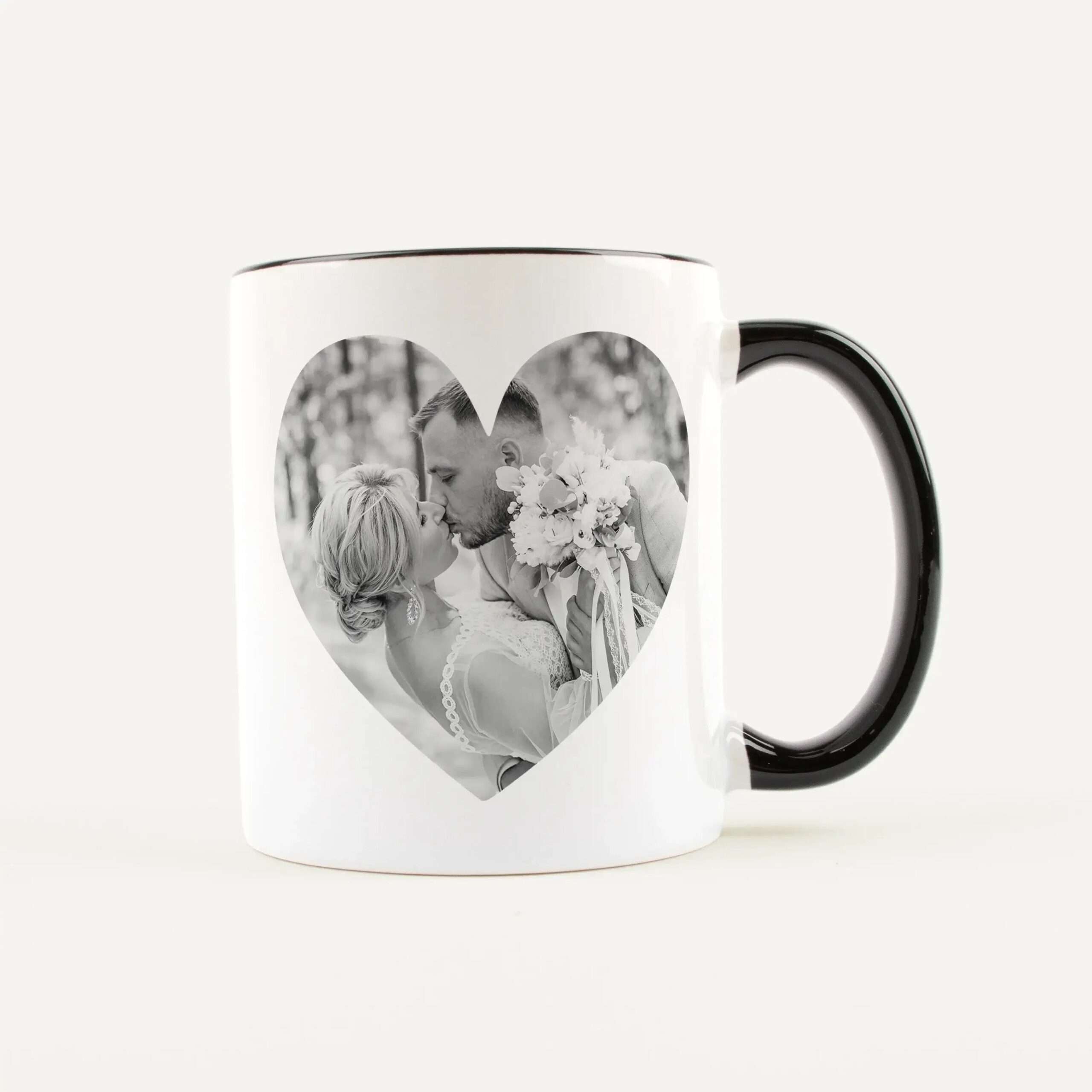White mug with a black handle featuring a heart-shaped photo window showing a couple kissing in black and white.