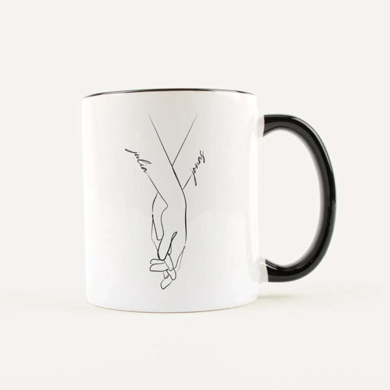 White mug with a black abstract line drawing along its side, handle on the right, against a pale background.