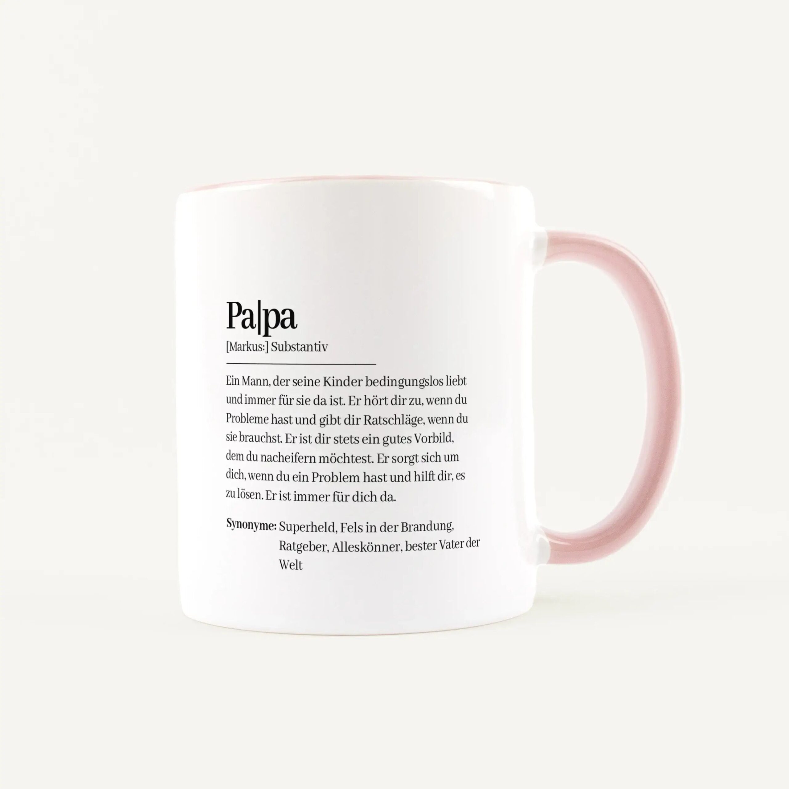 White ceramic mug with a pink handle showing a German dictionary-style printed entry and definition text.