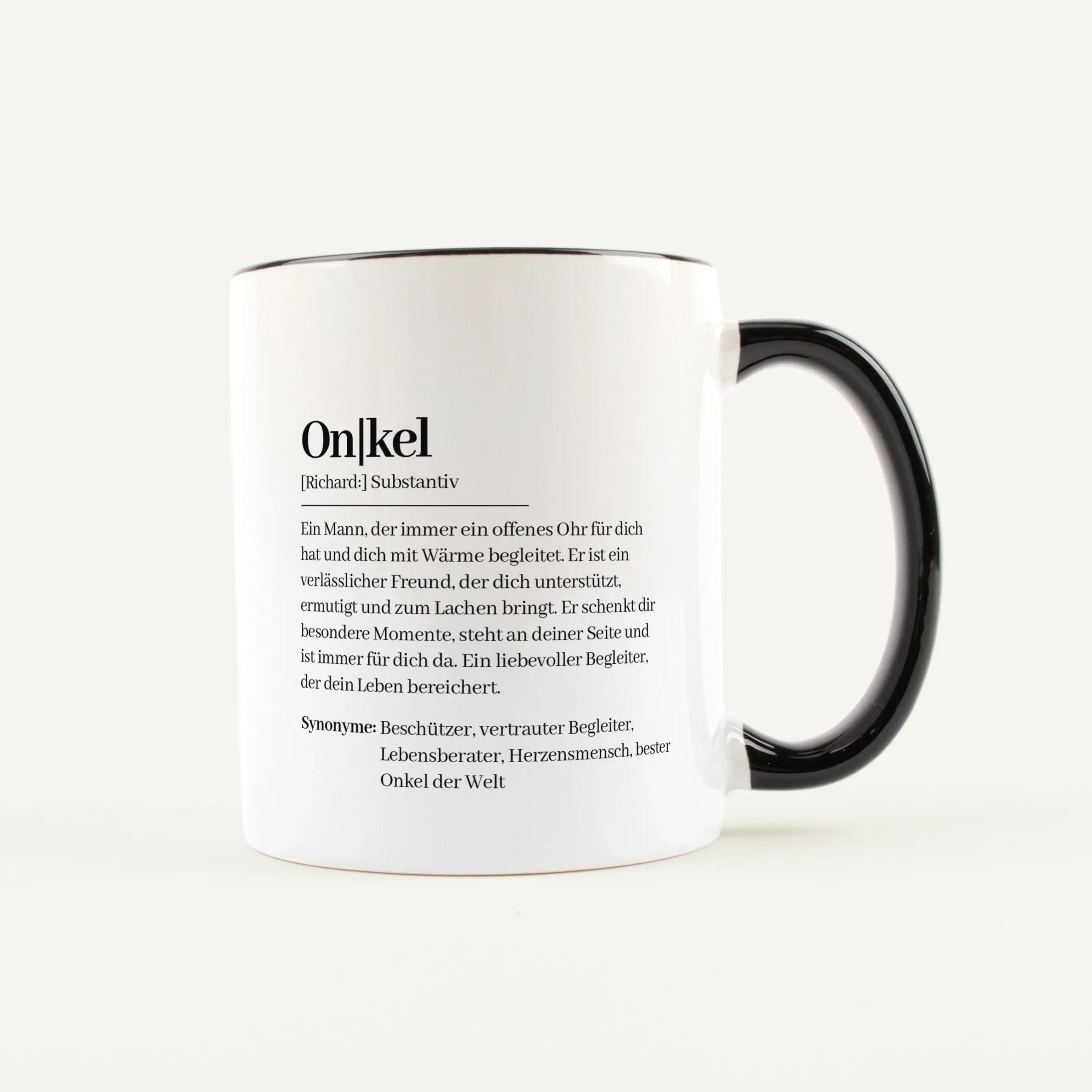Close-up of a white mug with a black handle, showing a dictionary-style German entry for the word 'Onkel'.