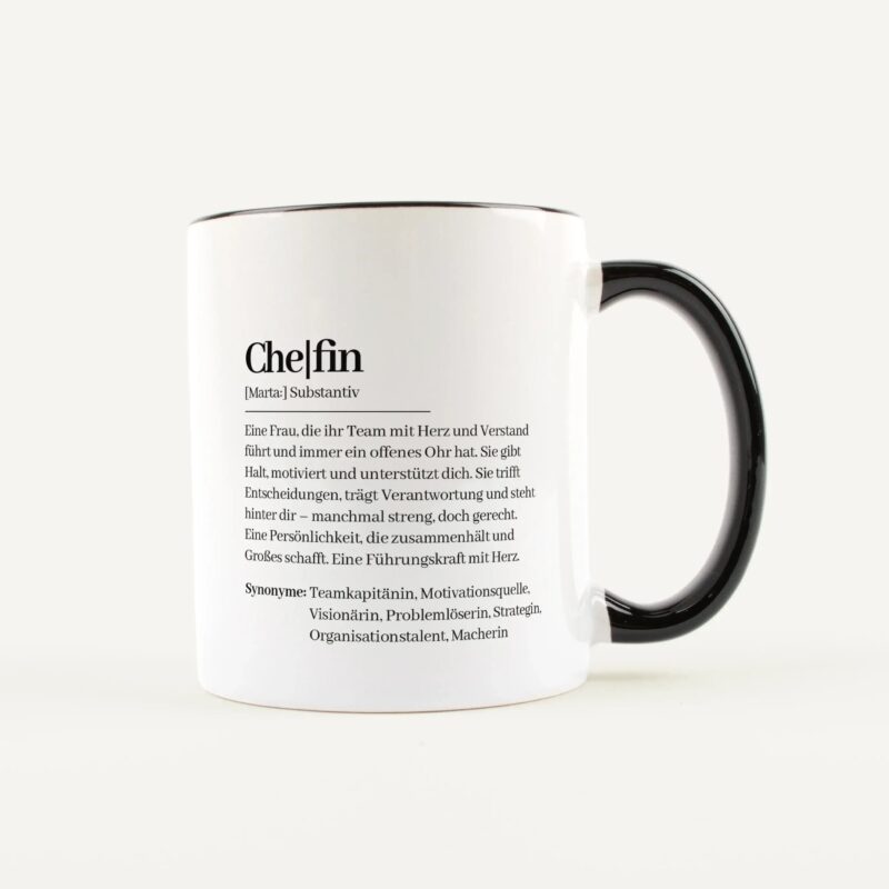 White mug with a black handle showing printed German text along the side.