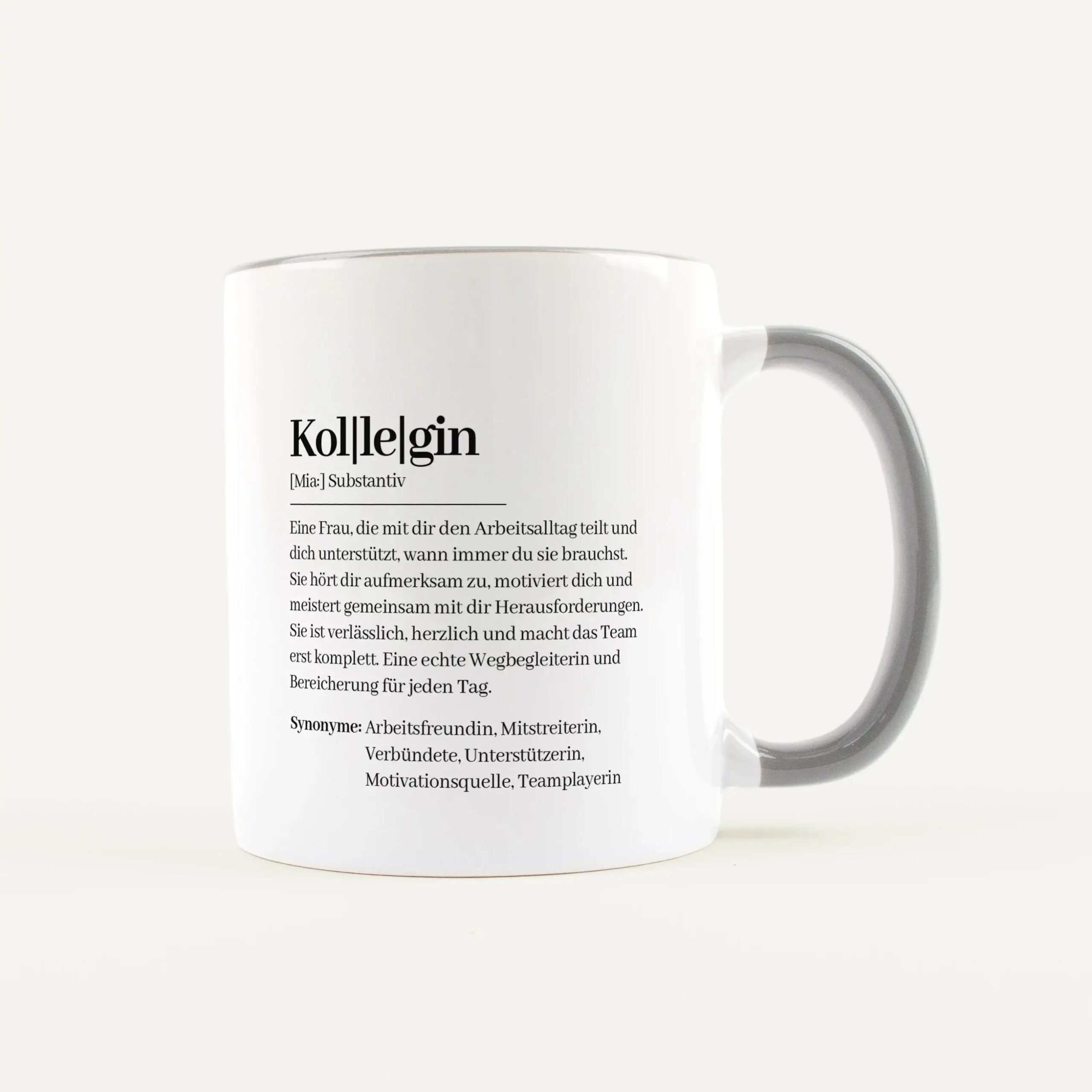 White ceramic mug with printed German dictionary-style entry, including the word and its definition on the side.