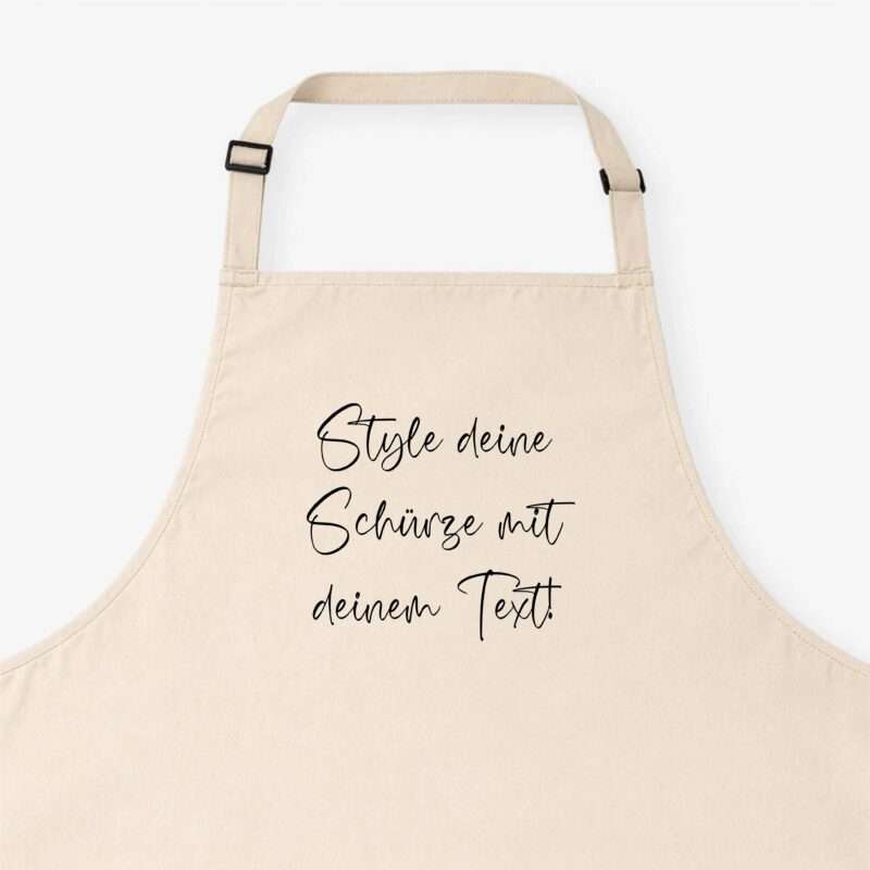 Beige apron with adjustable straps and black buckles shown against a white background, with cursive German text partially visible.