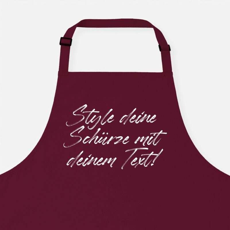 Maroon apron with adjustable straps and white cursive text on the front.