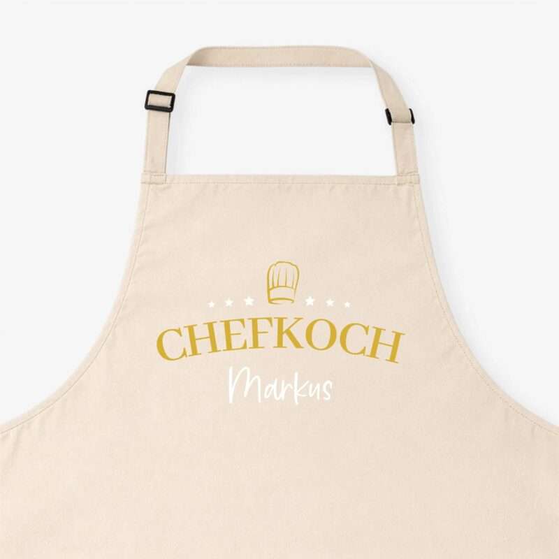 Beige apron with adjustable straps and yellow text reading 'CHEFKOCH' across the chest area.